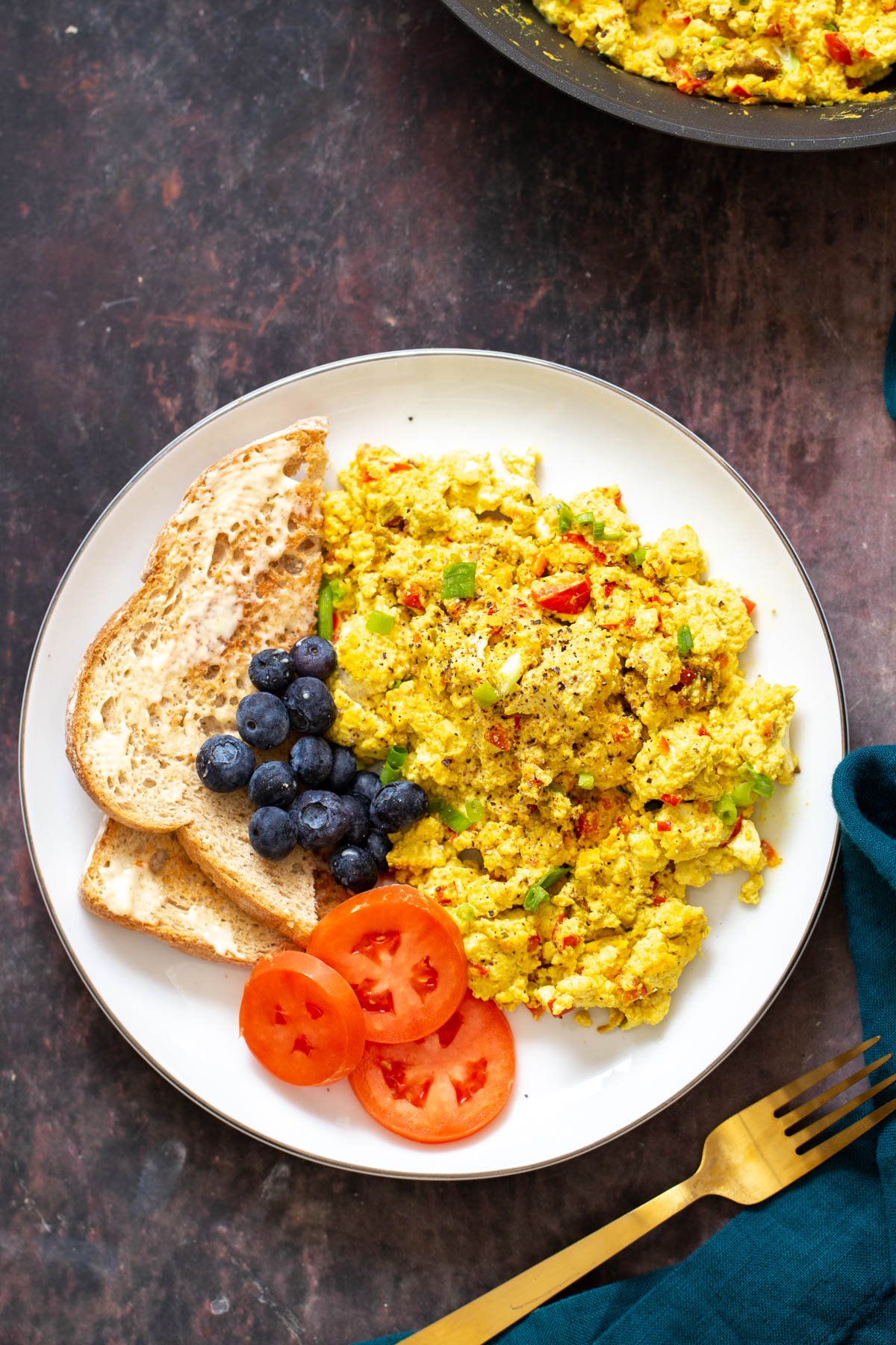 vegan tofu scramble served with a side of toast and vegetables