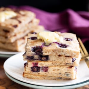 vegan sheet pan pancakes stacked on a white plate
