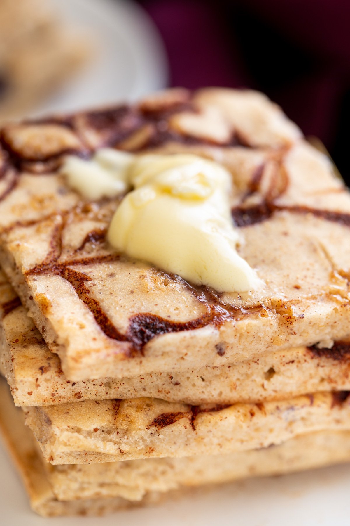 vegan cinnamon swirl sheet pan pancakes topped with a dollop of vegan butter 