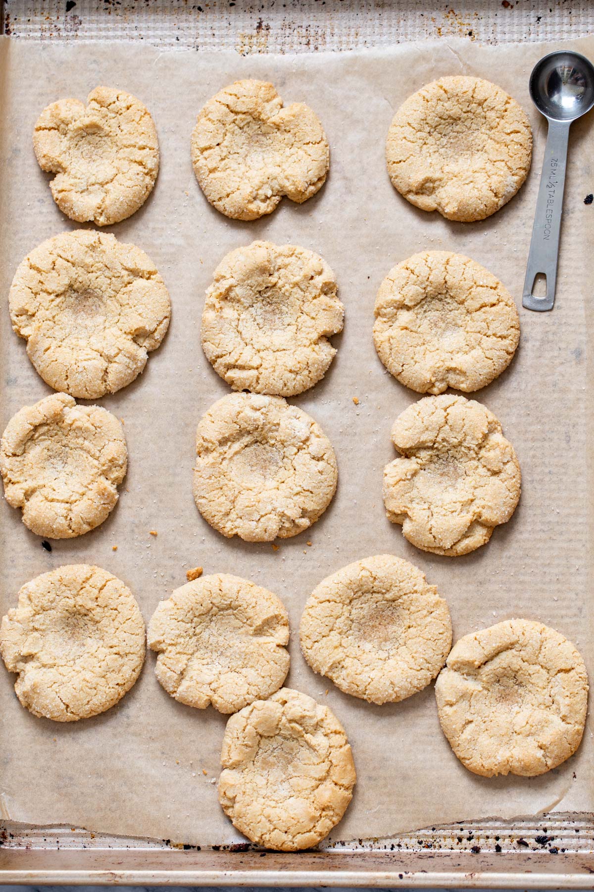 freshly baked glutenfree thumprint cookies on a baking sheet