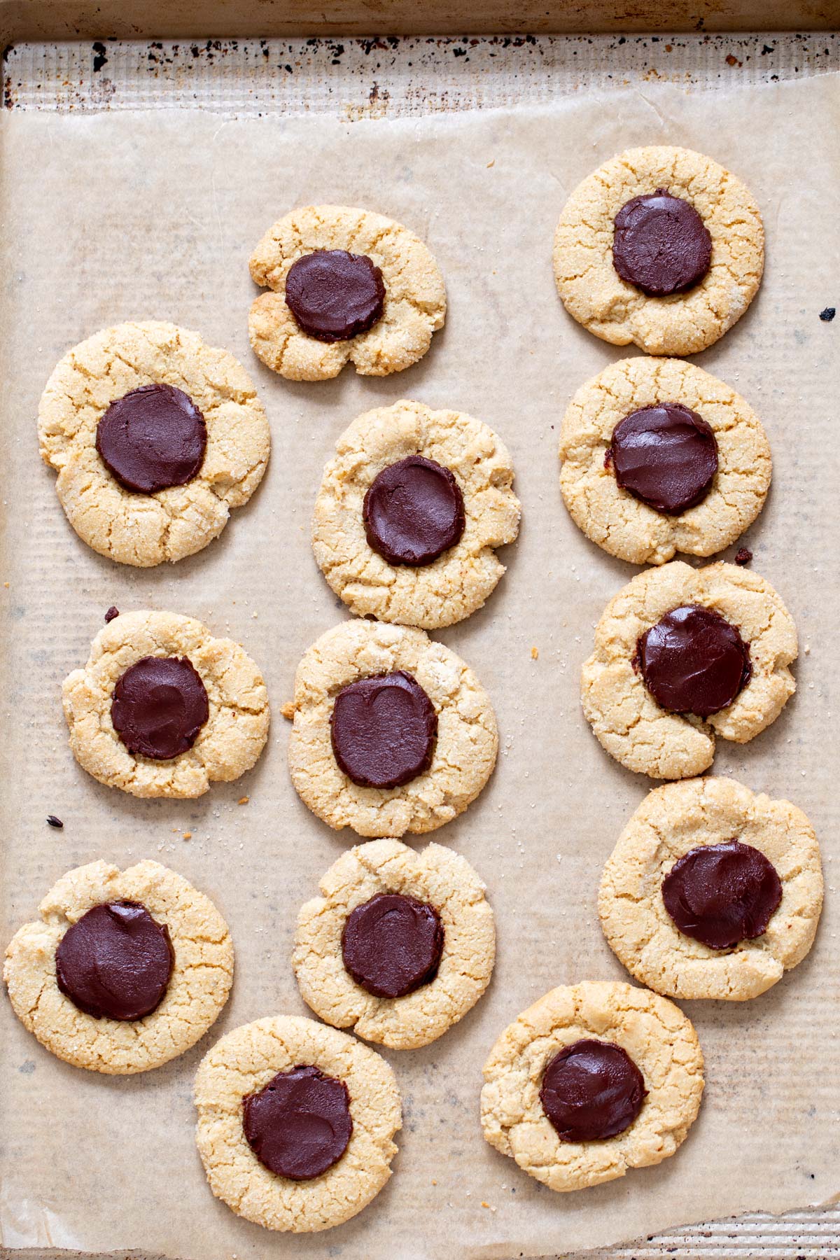 gluten free thumbprint cookies vegan glutennfree chocolate thumbprint cookies on a baking sheet