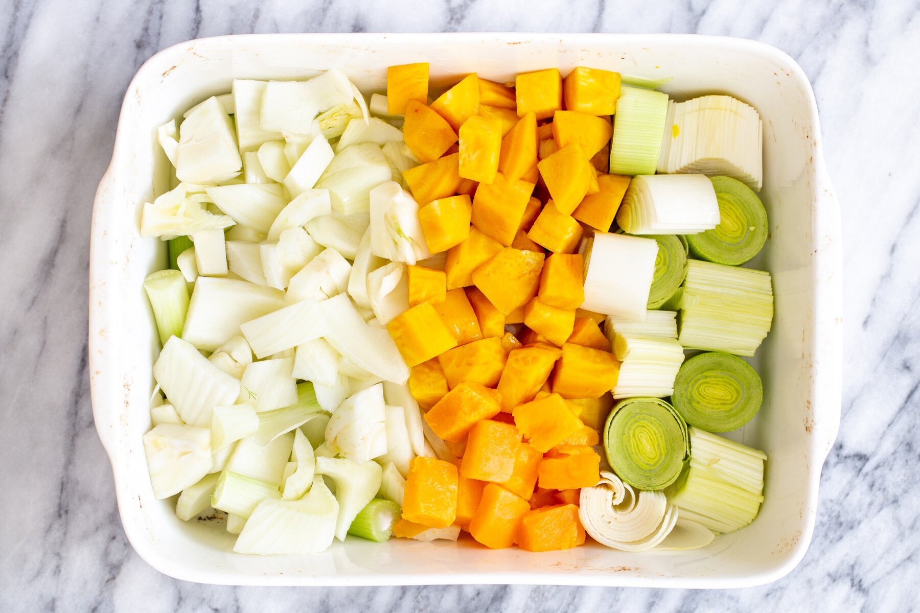 chopped root vegtetables in a casserole dish