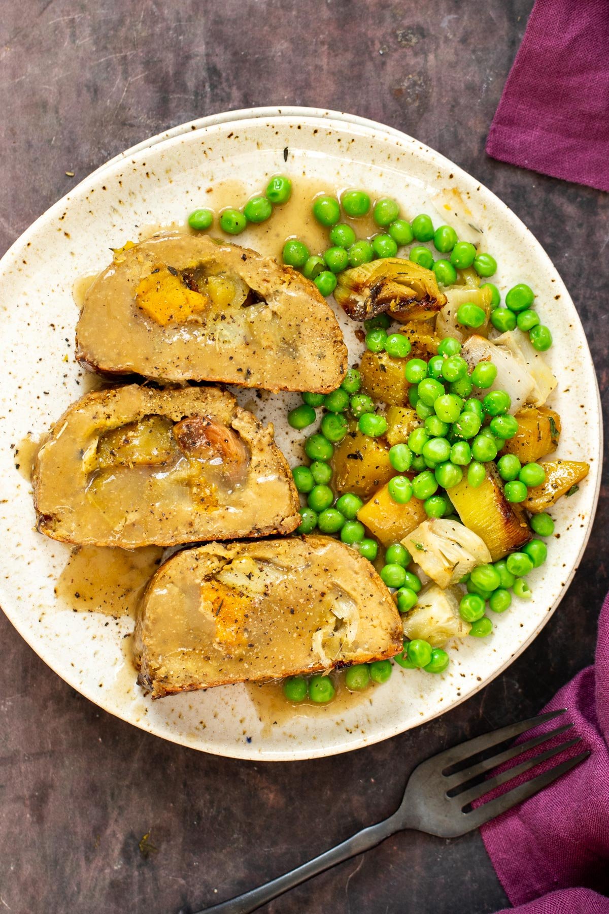 holiday roast with a side of peas and roasted vegetables