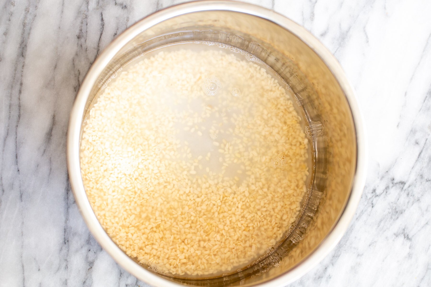 black gram being soaked in warm water