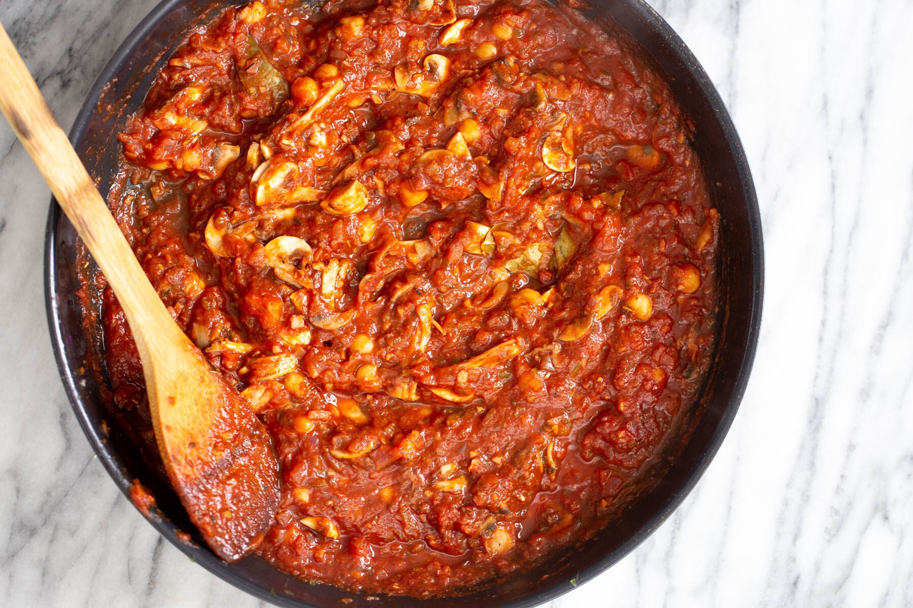 vegan stuffed bell peppers sauce for vegan stuffed bell peppers in a black skillet