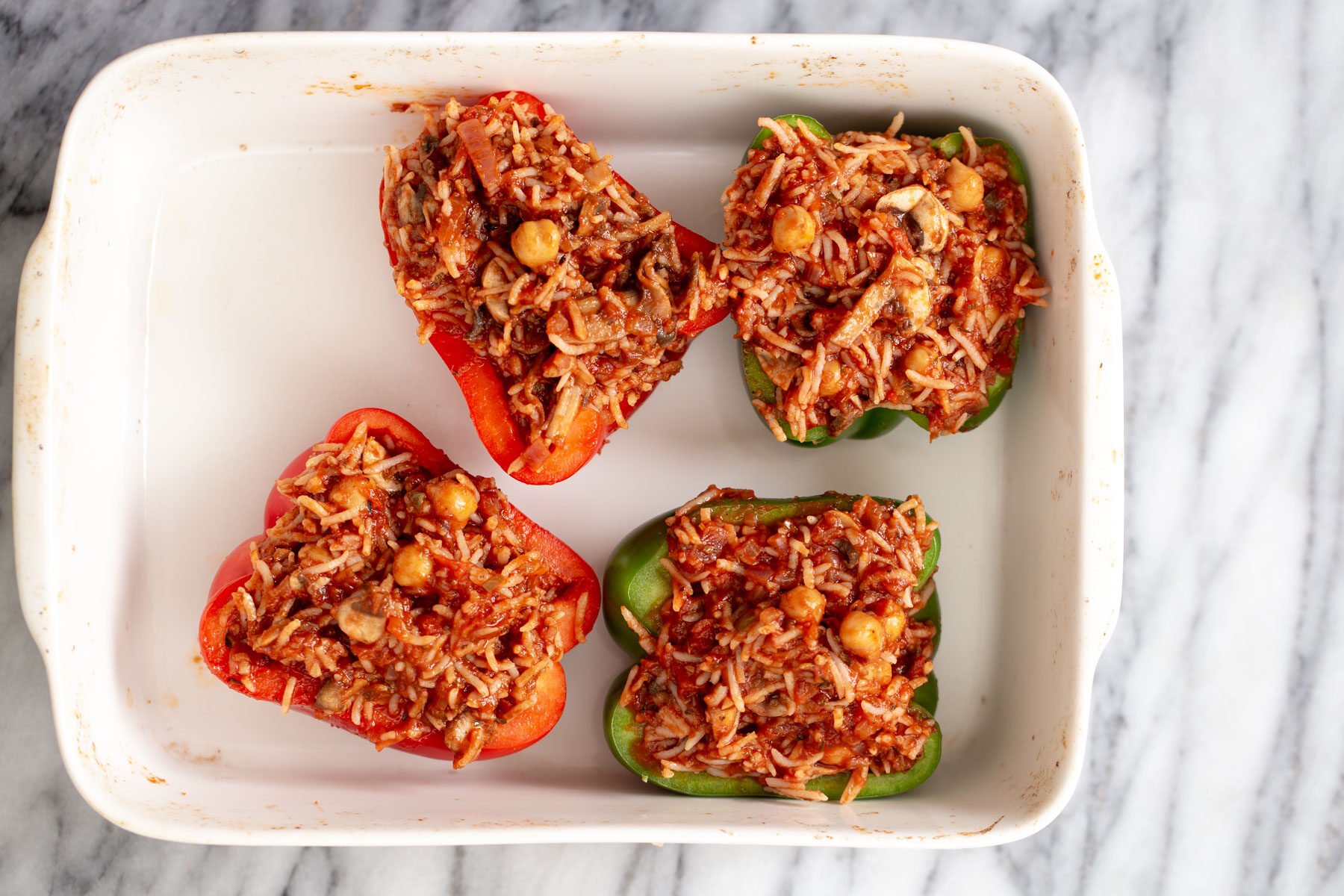 vegan stuffed bell peppers filled stuffed bell peppers in a casserole dish