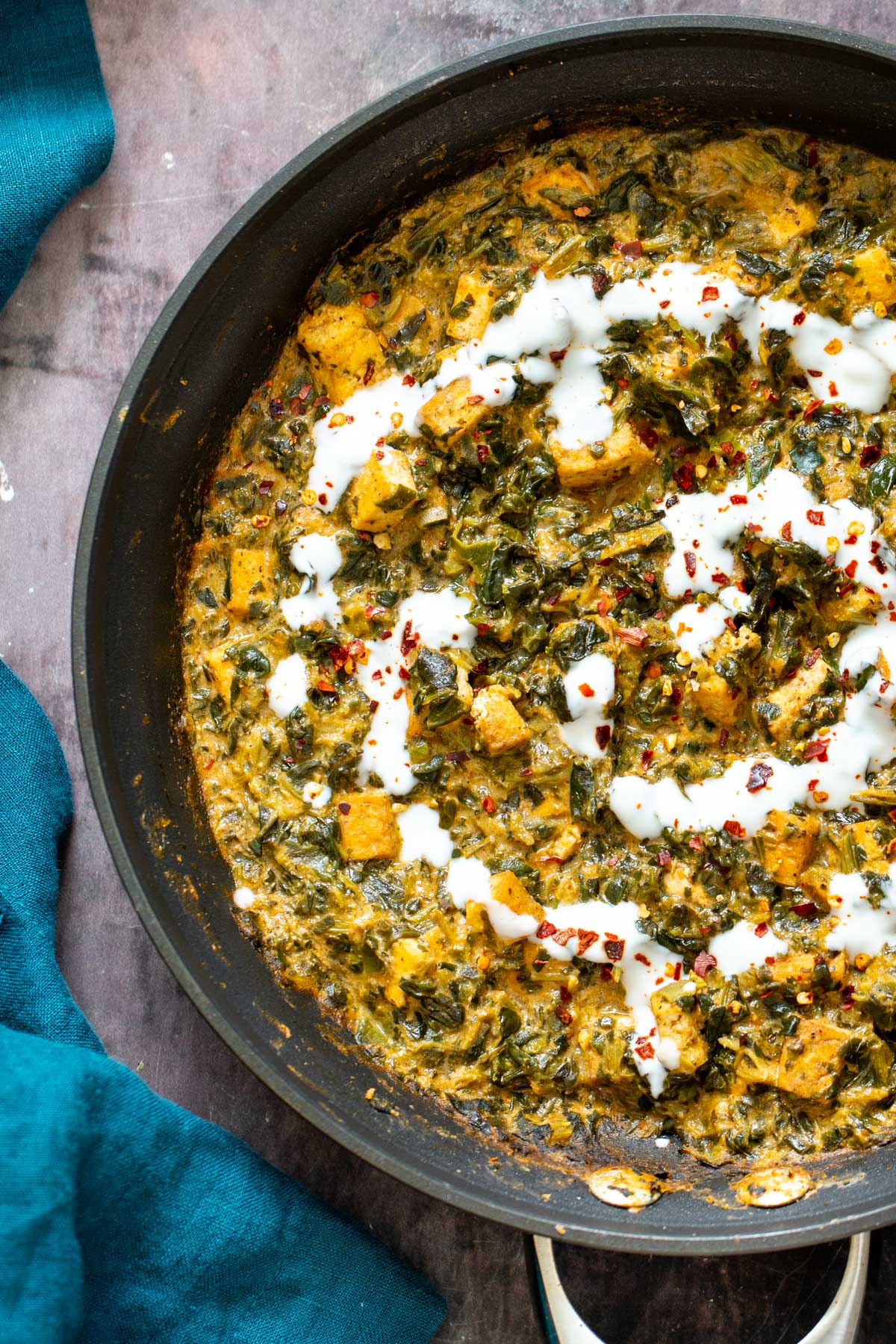 spinach tofu curry a skillet with spinach tofu curry drizzled with yogurt