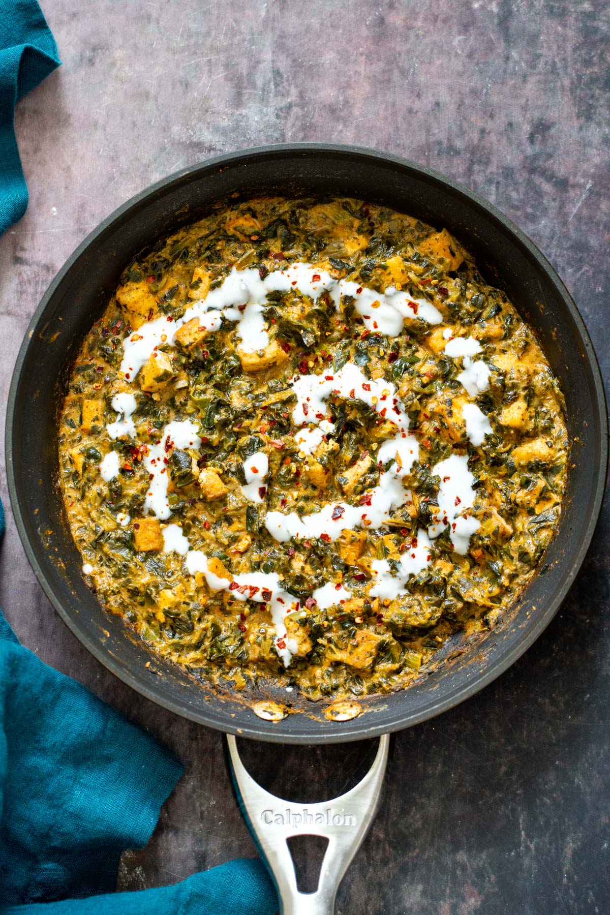 spinach tofu curry a skillet with spicy vegan spinach tofu curry drizzled with vegan yogurt