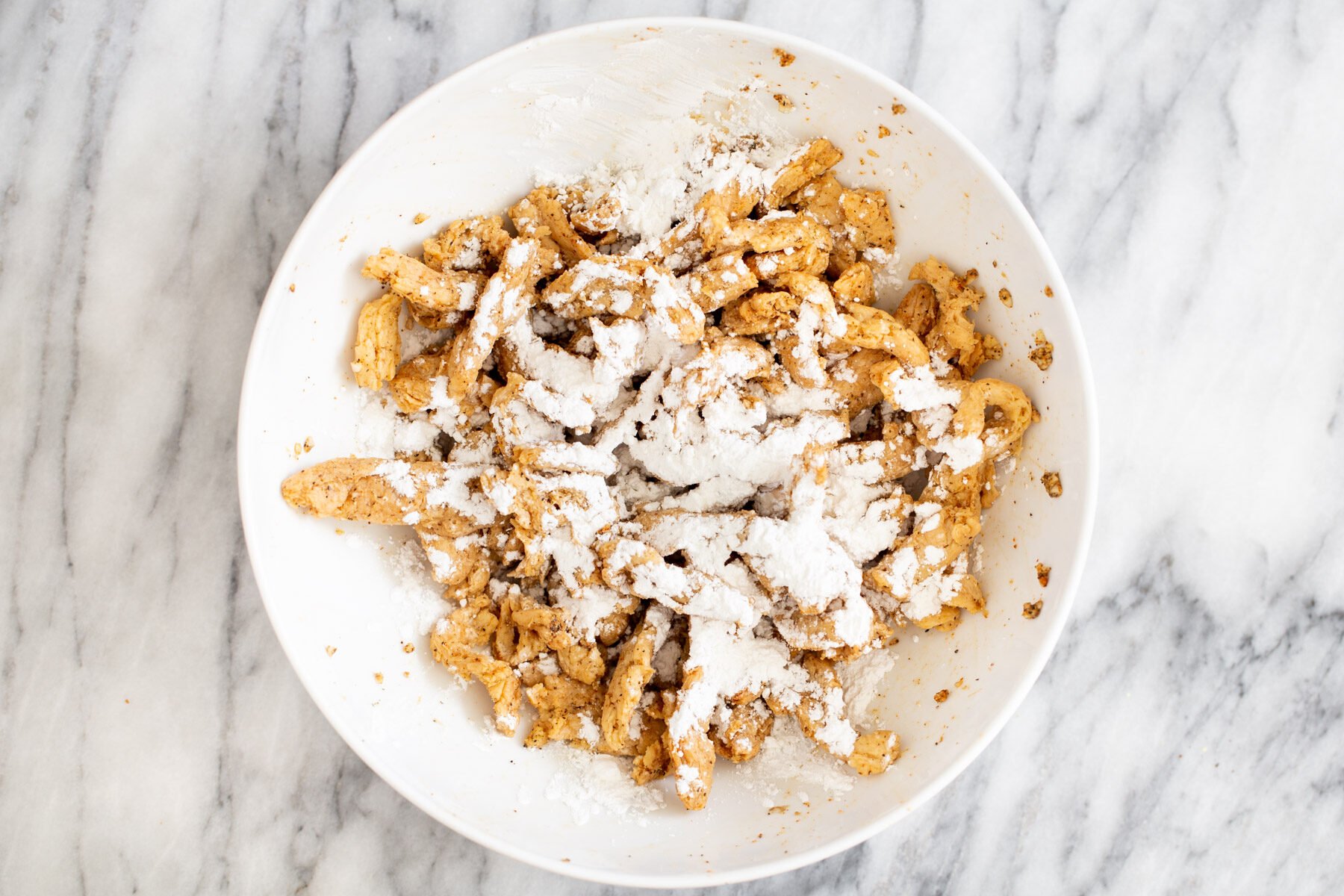 vegan soycurls sprinkled with cornstarch in a bowls