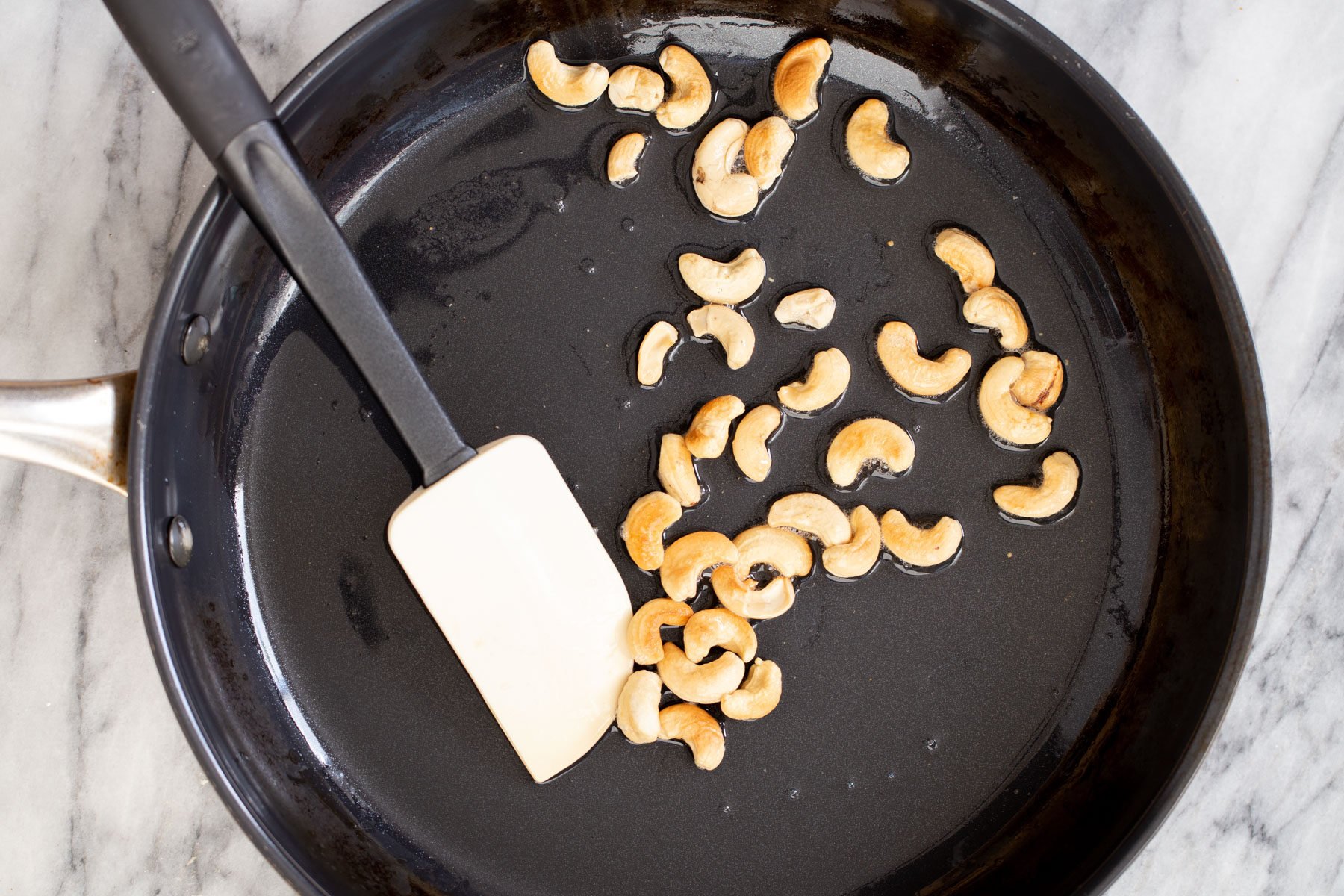 cashew nuts in a sauteeing pan