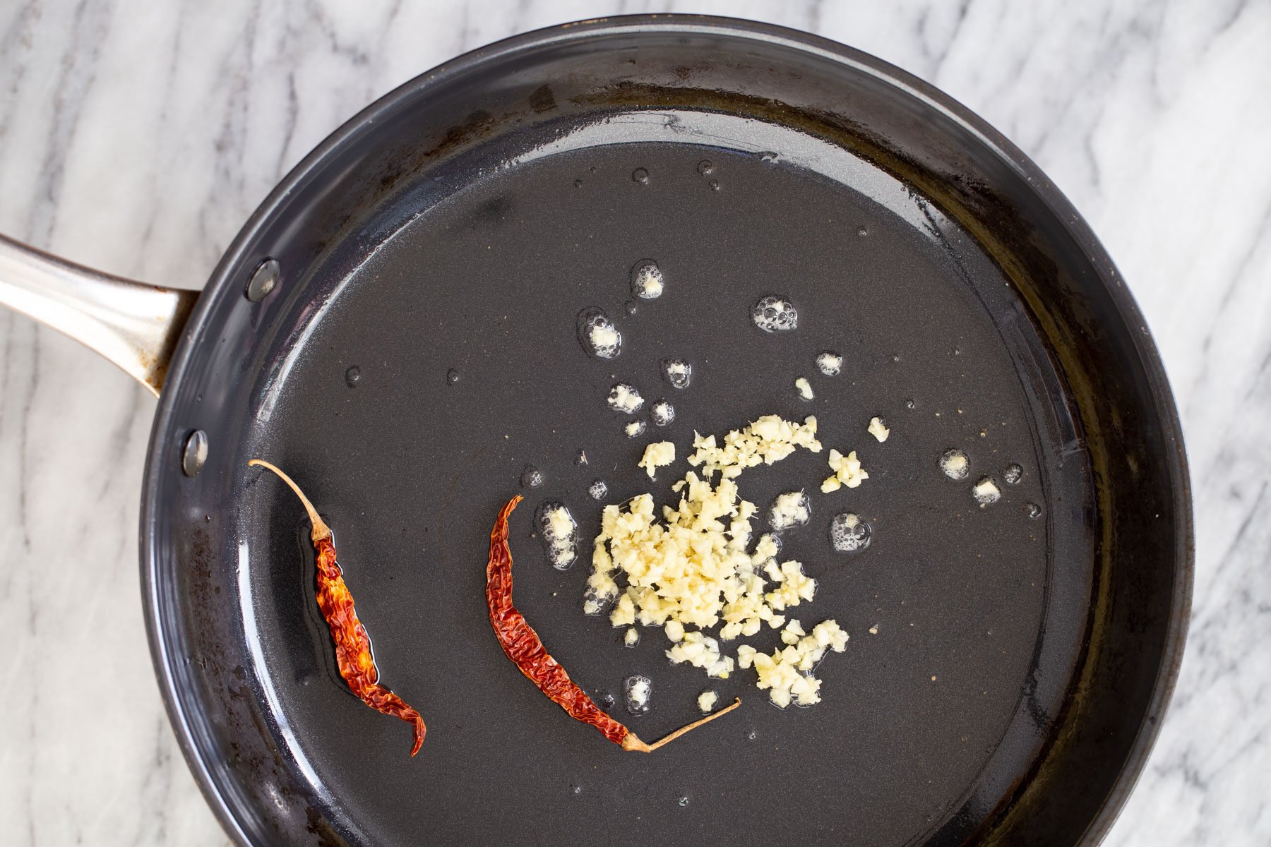 chili and garlic in a black sauteeing pan