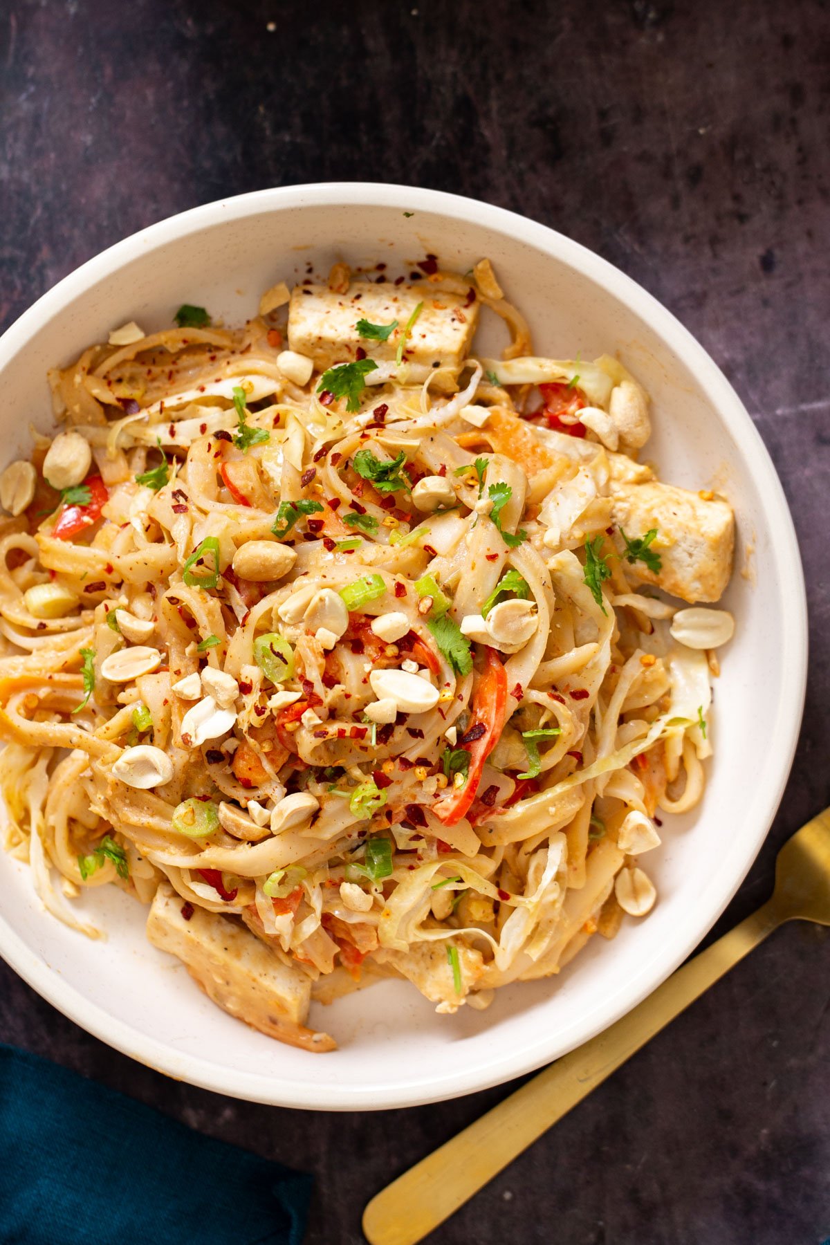 a serving of vegan peanut butter noodles in creamy peanut sauce