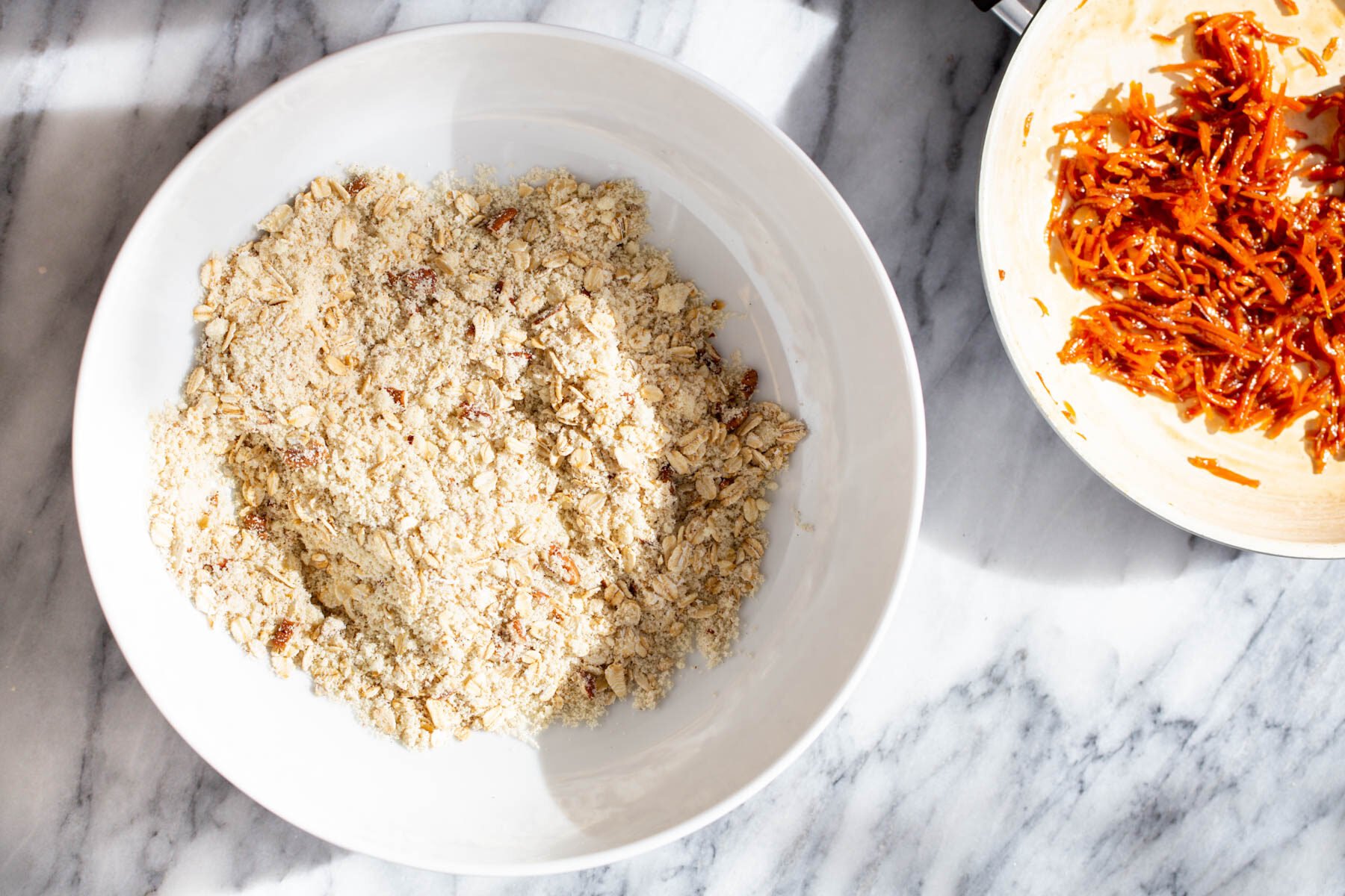 dry ingredients for oatmeal cookies and a bowl of caramelized carrots