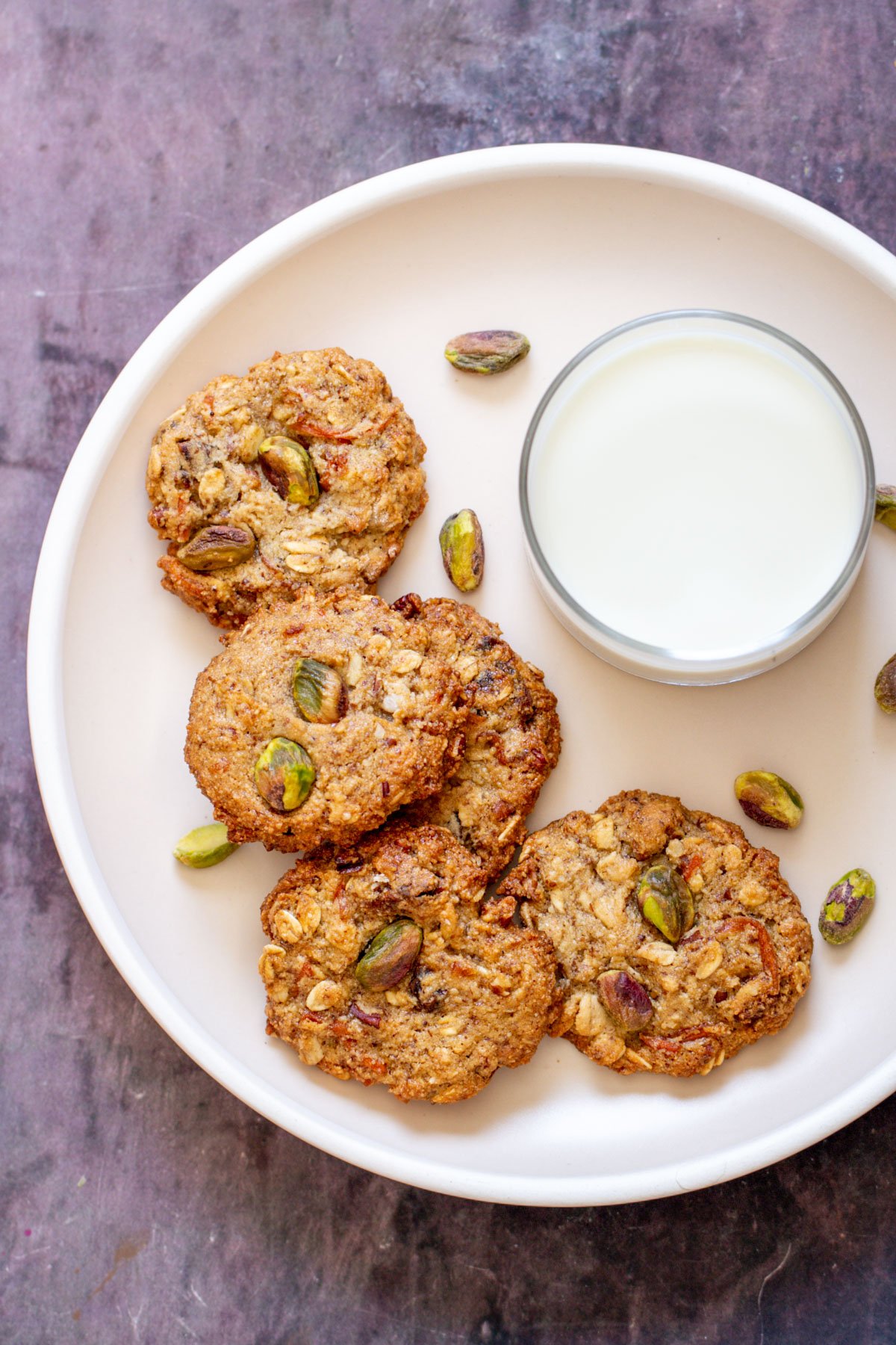 vegan carrot cake cakes and a glass of milk on a white plate