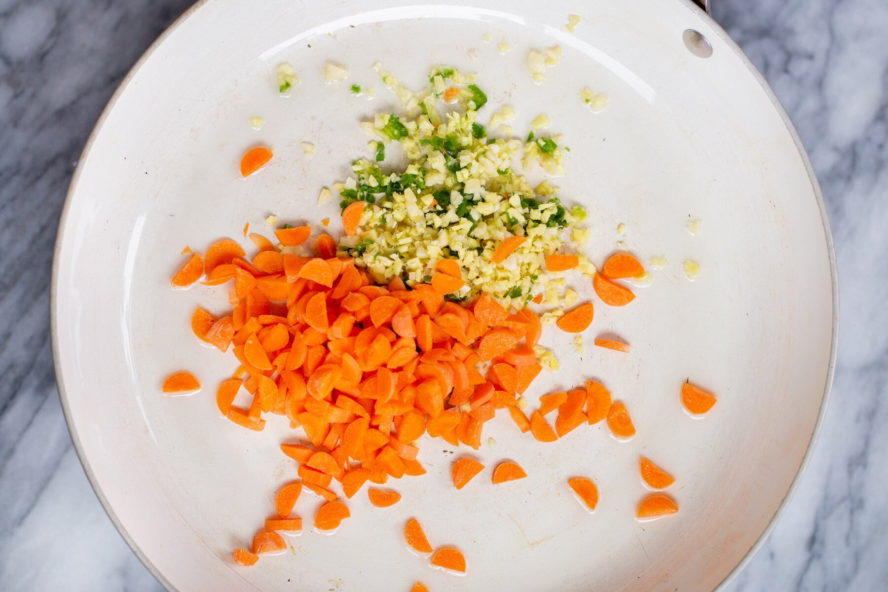 carrots ginger and chiles in a sauteeing pan