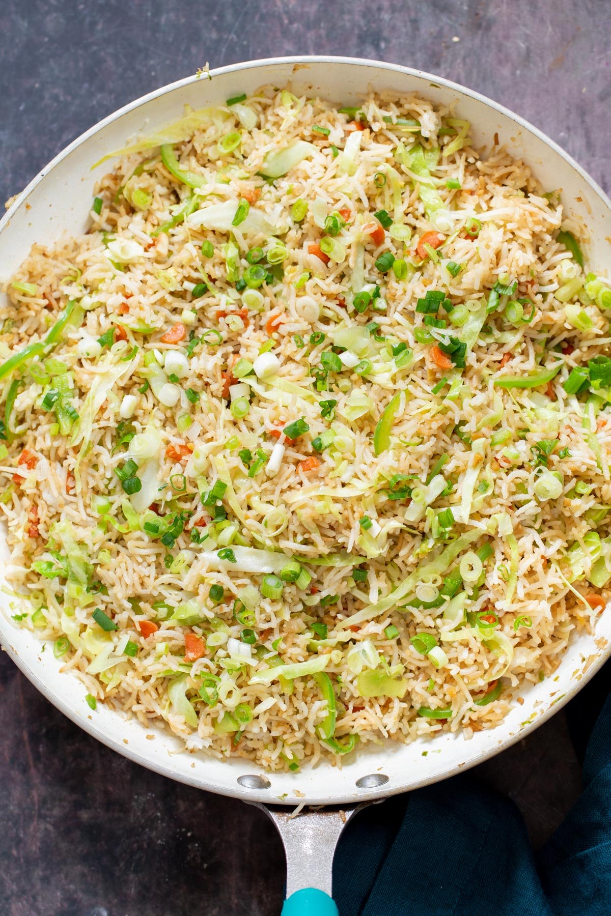 a frying pan with Indo Chinese Fried rice sprinkled with scallions
