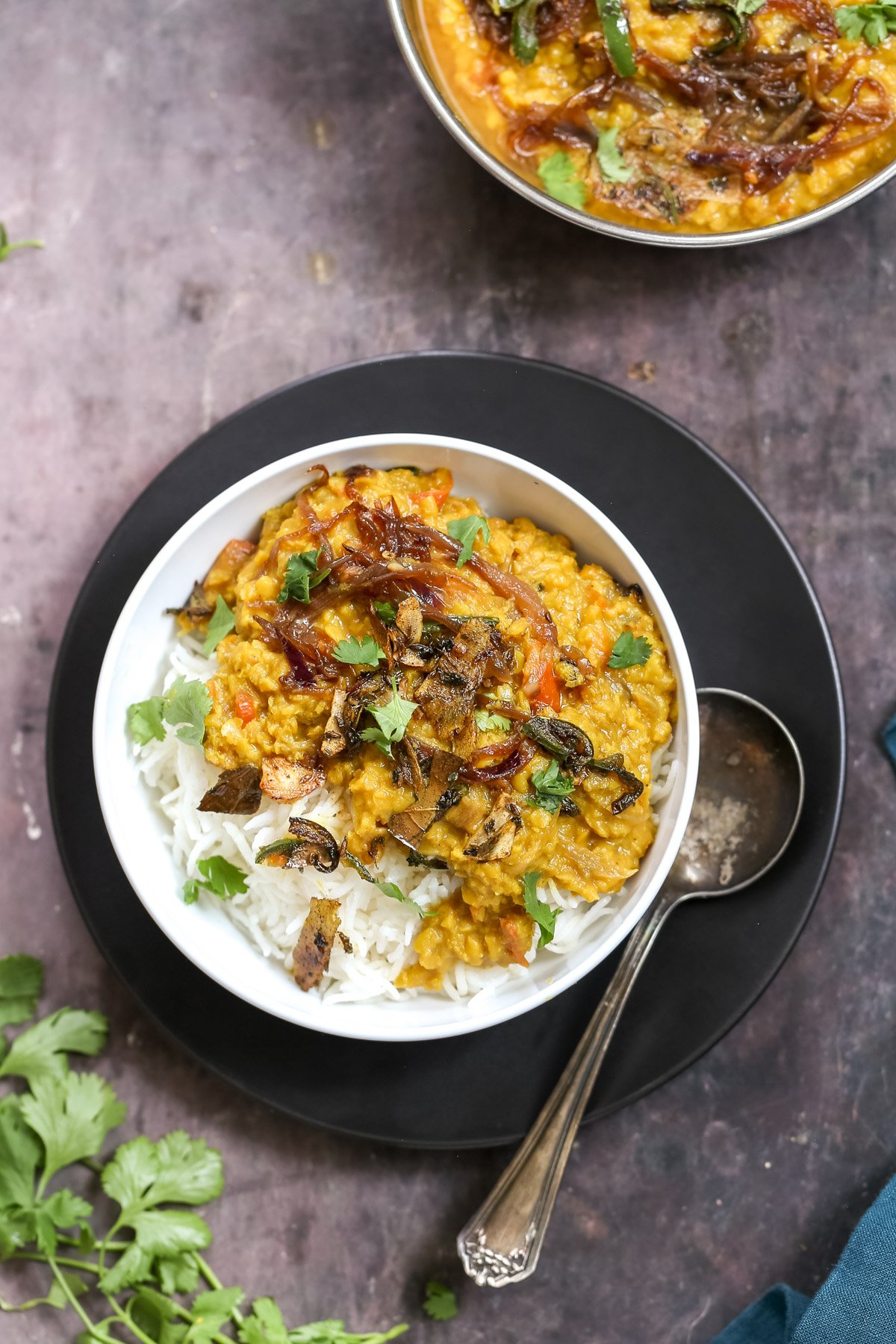 masoor dal tadka served over rice sprinkled with cilantro