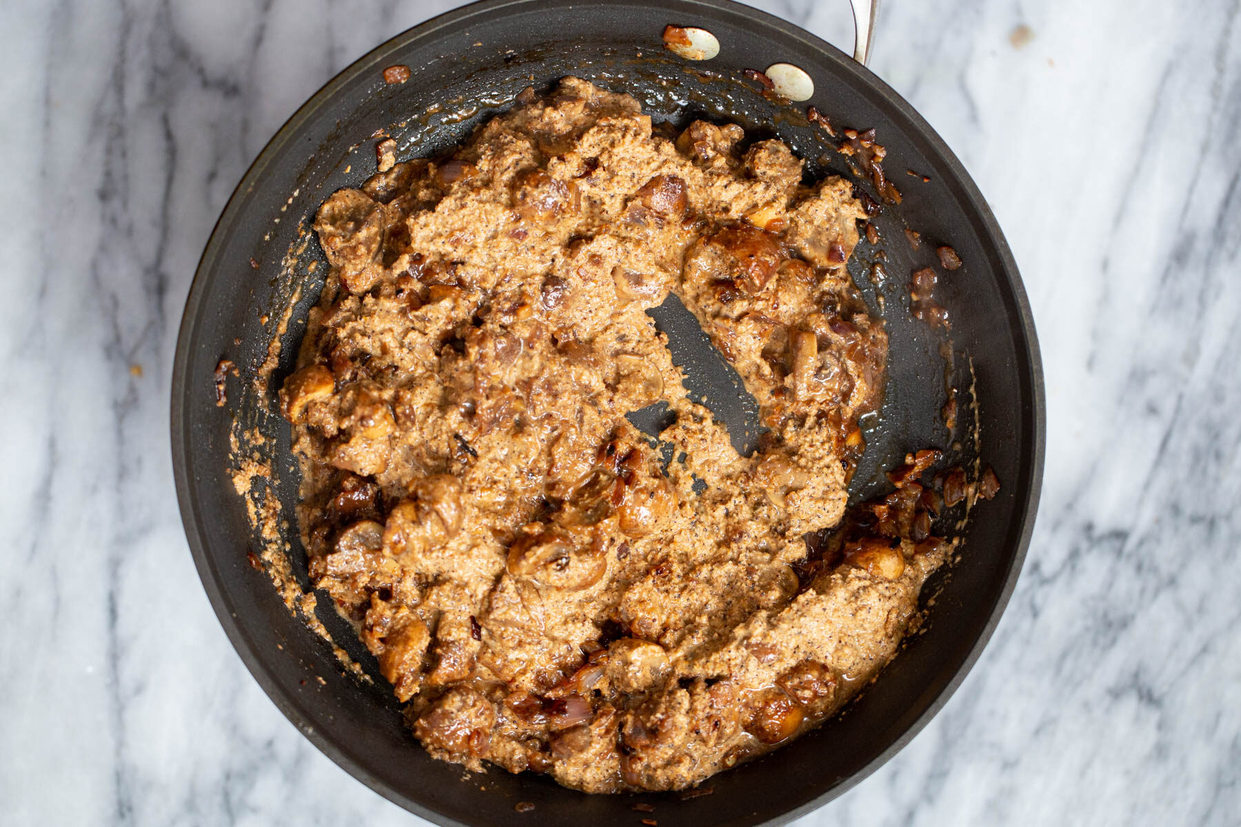a skillet with vegan mushroom xacuti