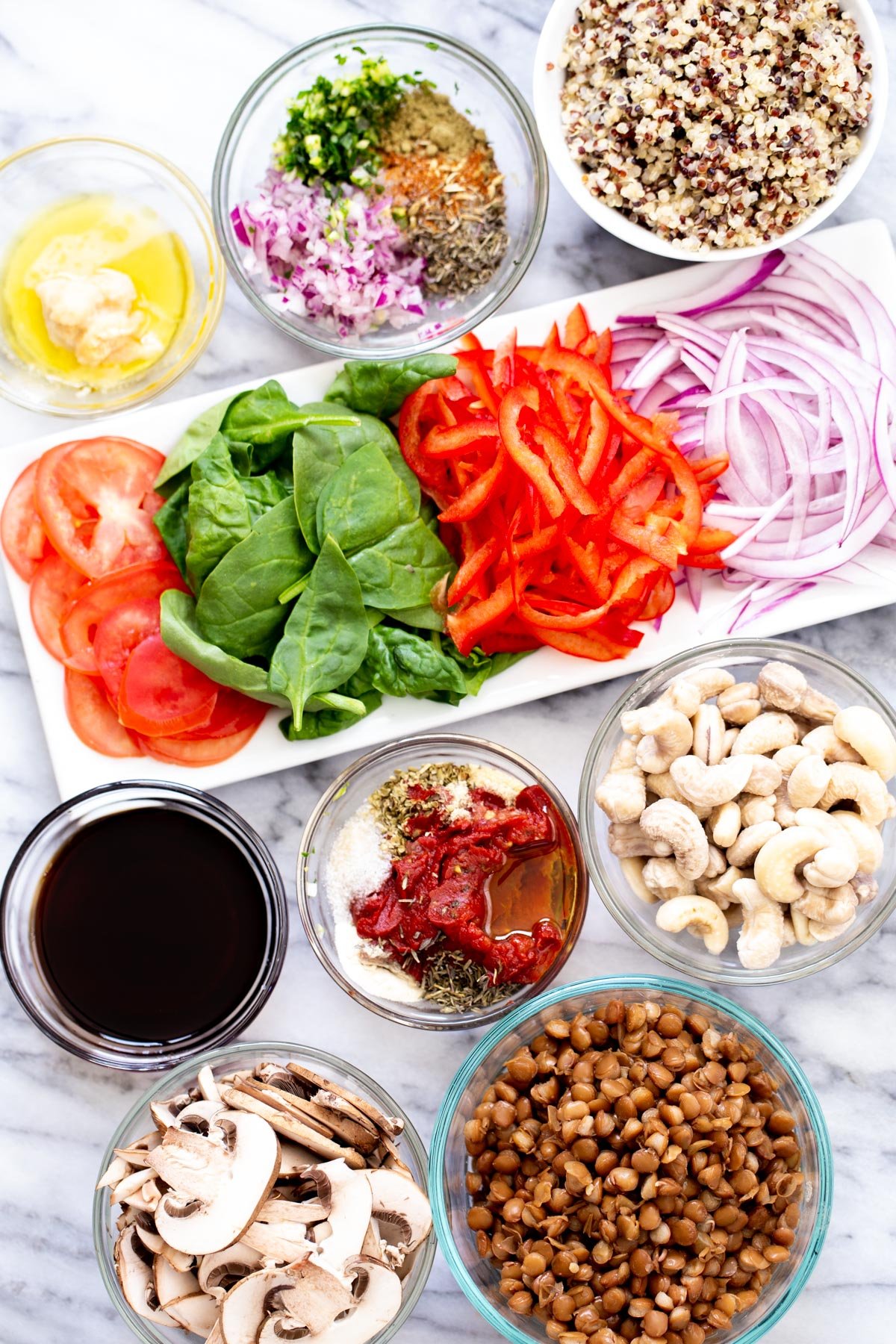 ingredients for making pizza bowls on a marble countertop