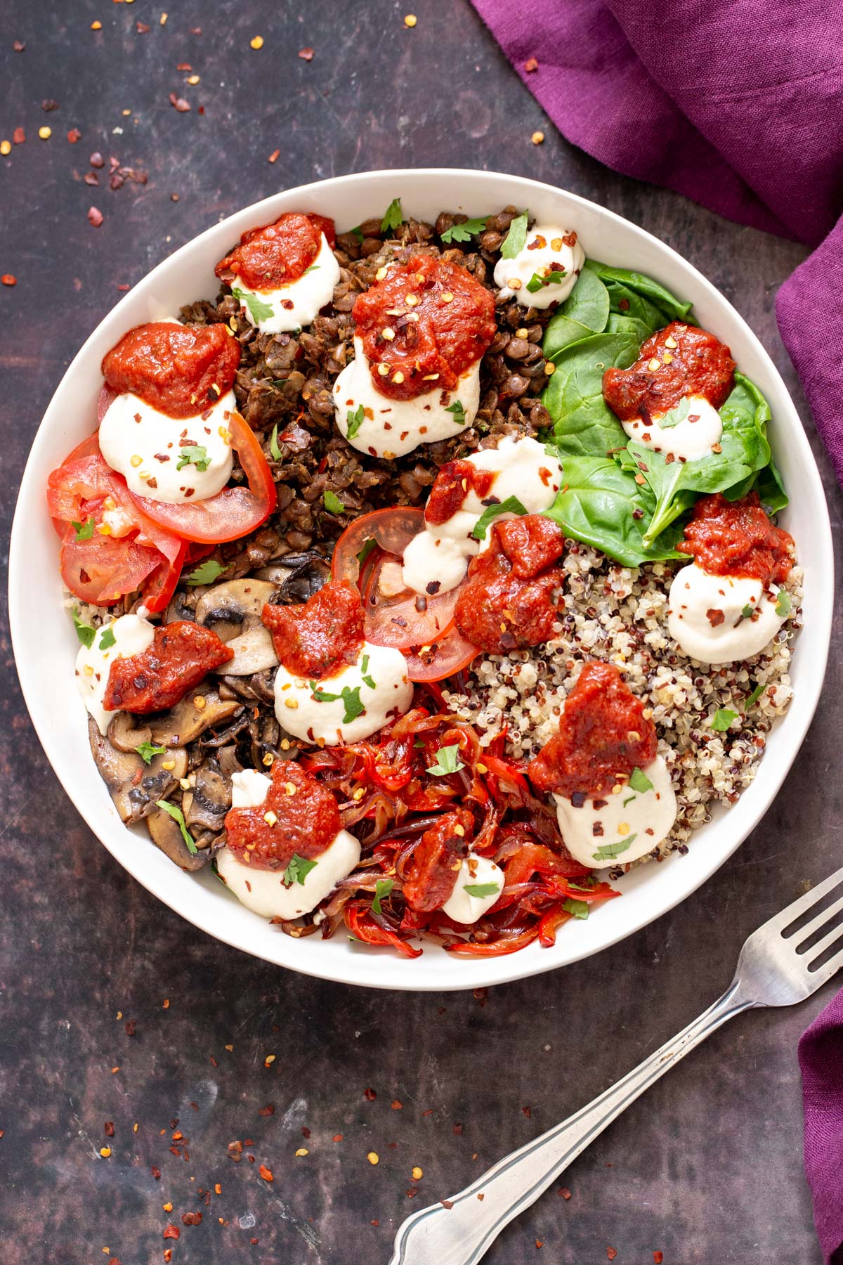 overhead shot of a vegan pizza bowl topped with cashew mozzarella cheese and basil