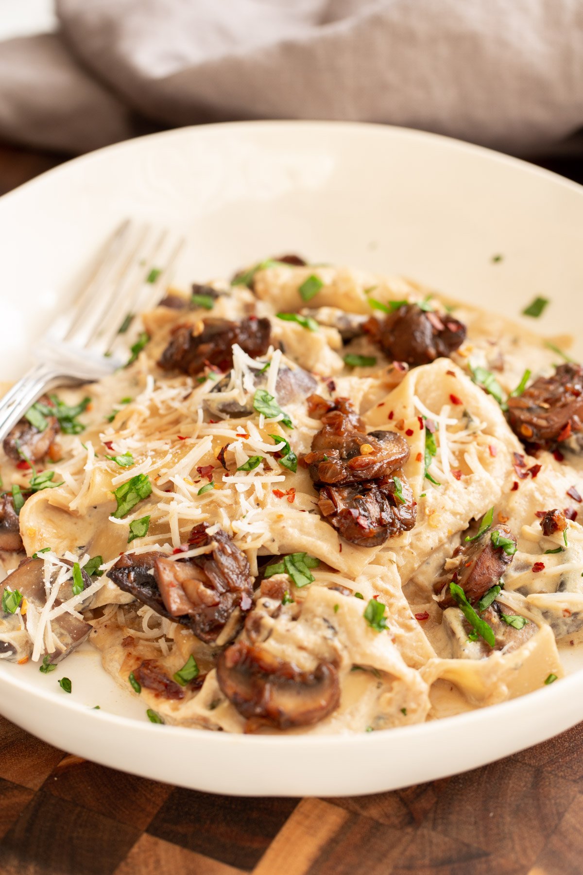 side view of a plate of vegan skillet lasagna with balsamic mushrooms and vegan bechamel