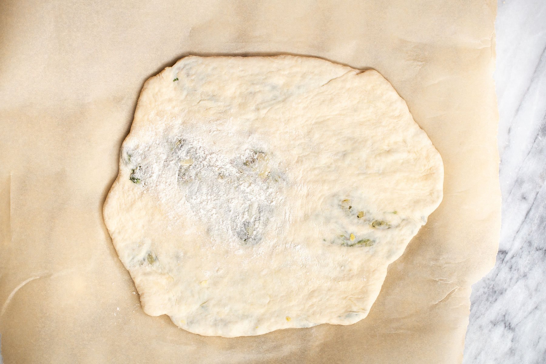 vegan spinach stuffed naan on a piece of baking paper