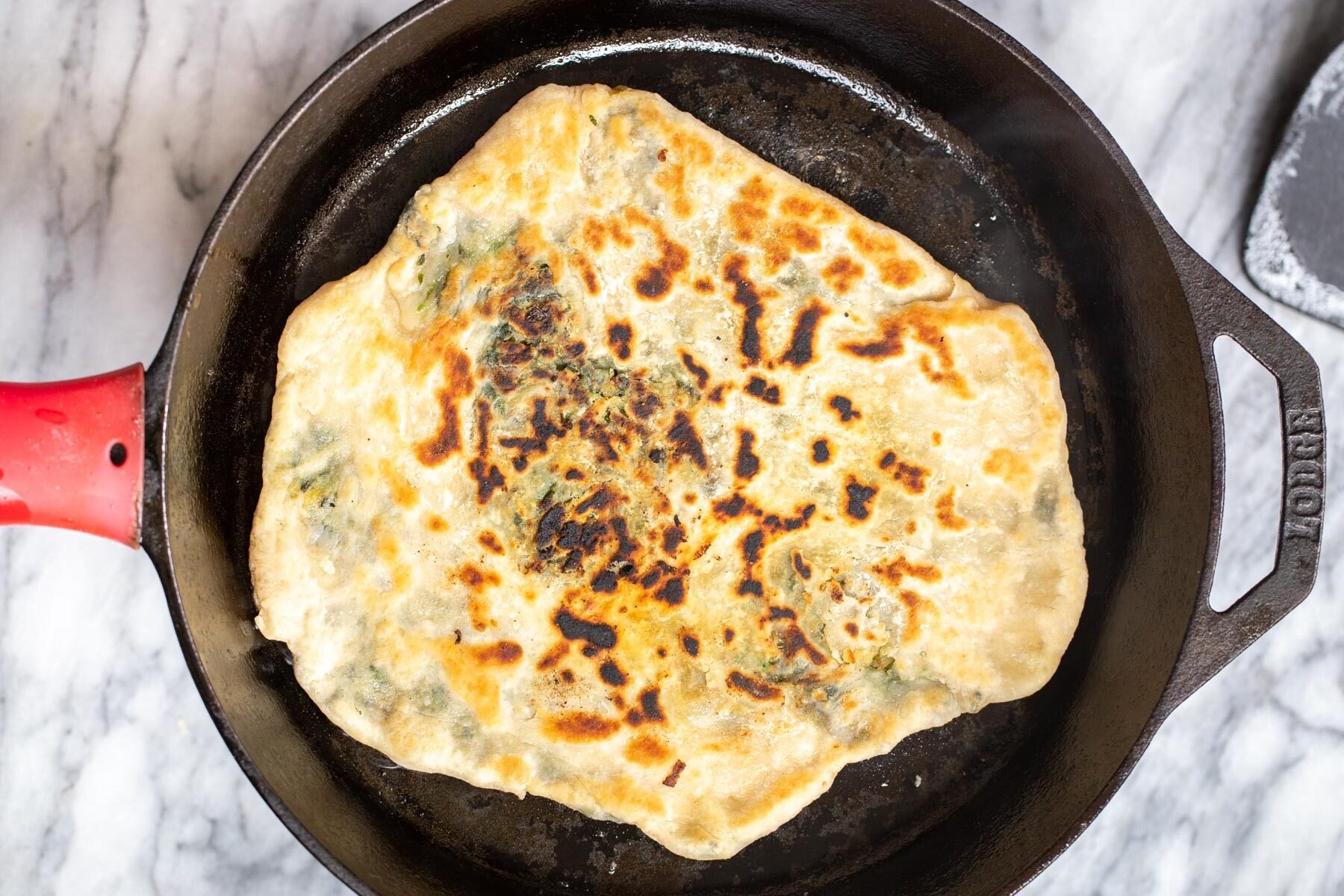 spinach naan flatbread baking in a skillet