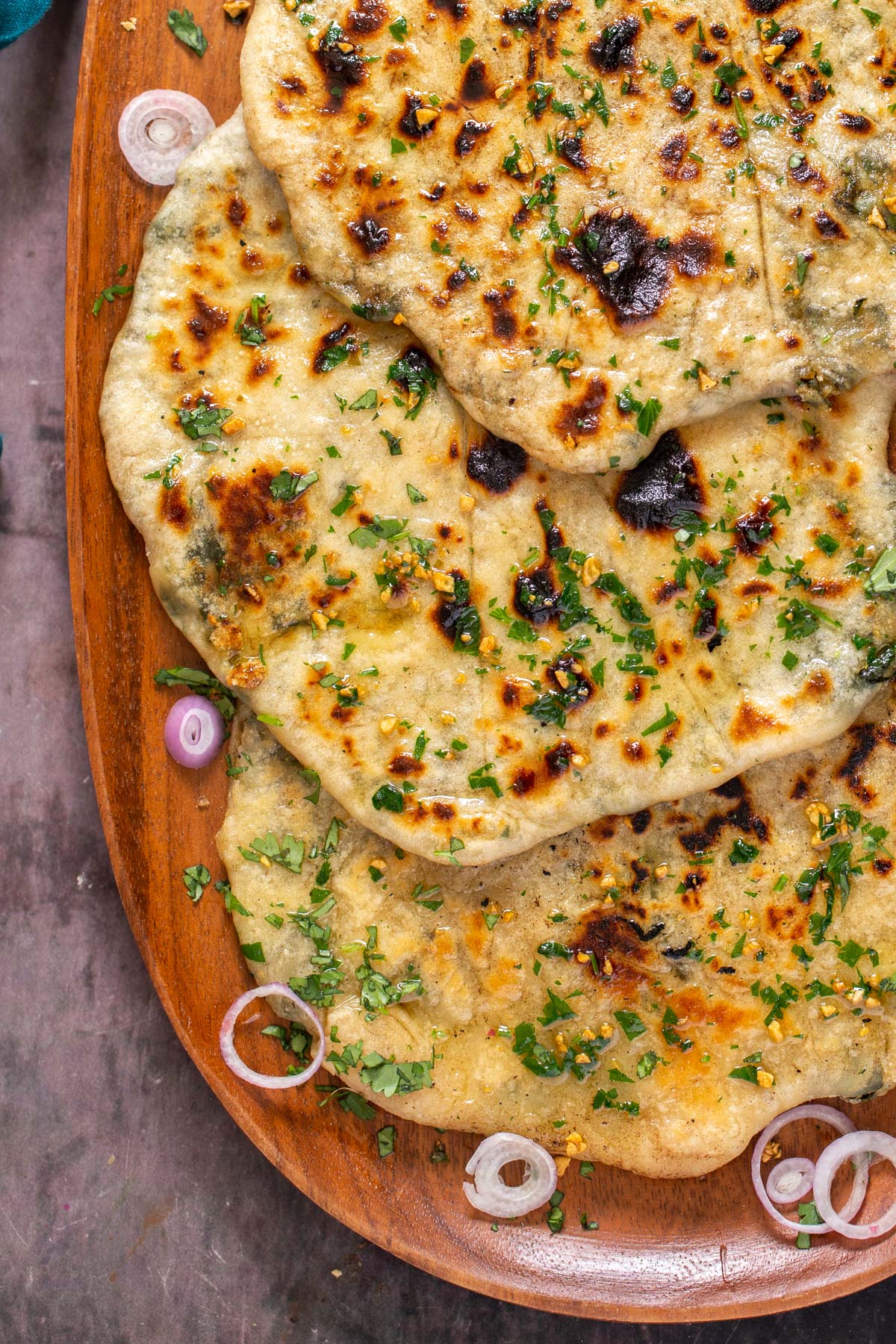 vegan stuffed spinach potato and cheese garlic naan topped with chopped herbs
