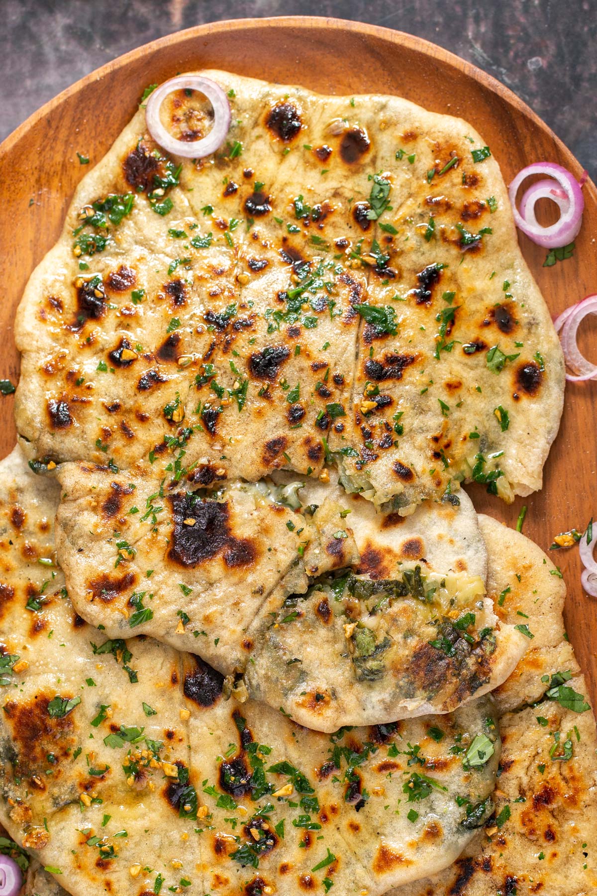 a platter with vegan potato spinach stuffed naan