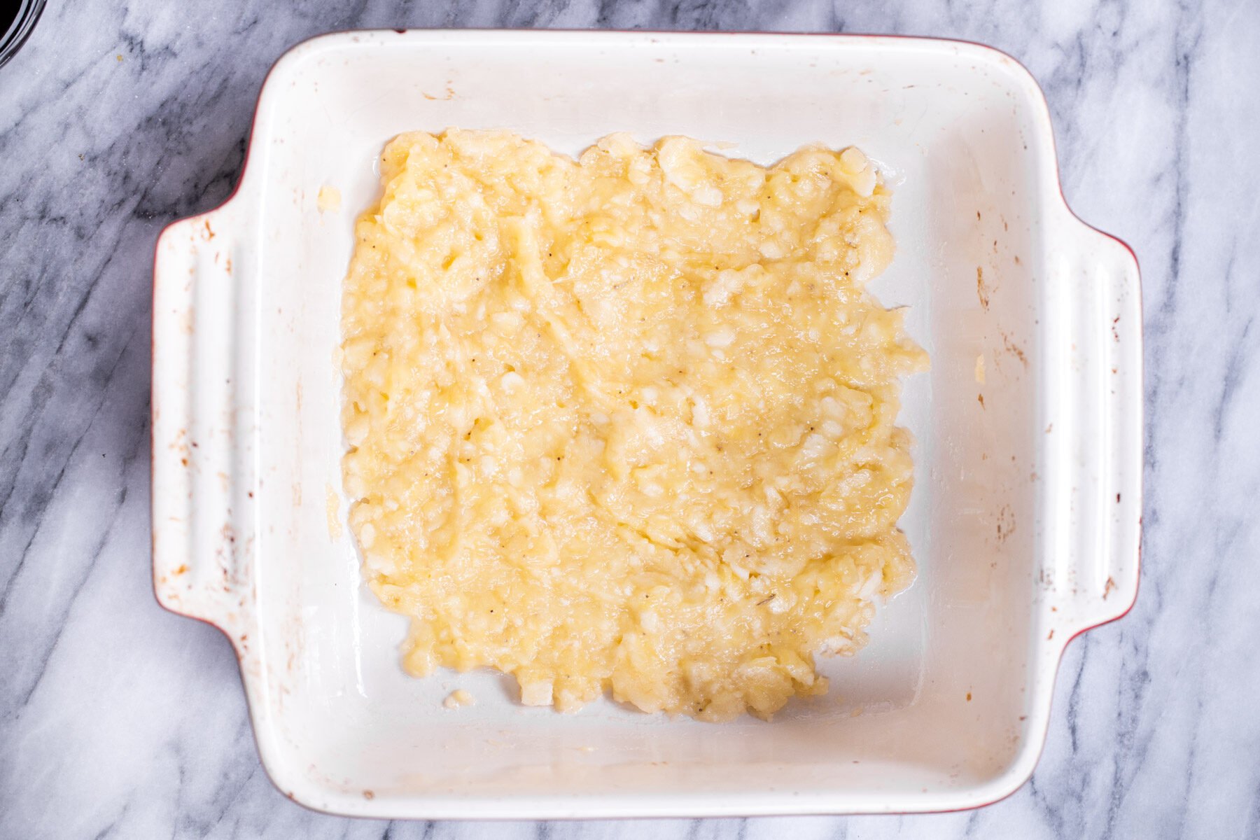 mashed bananas in a white casserole dish