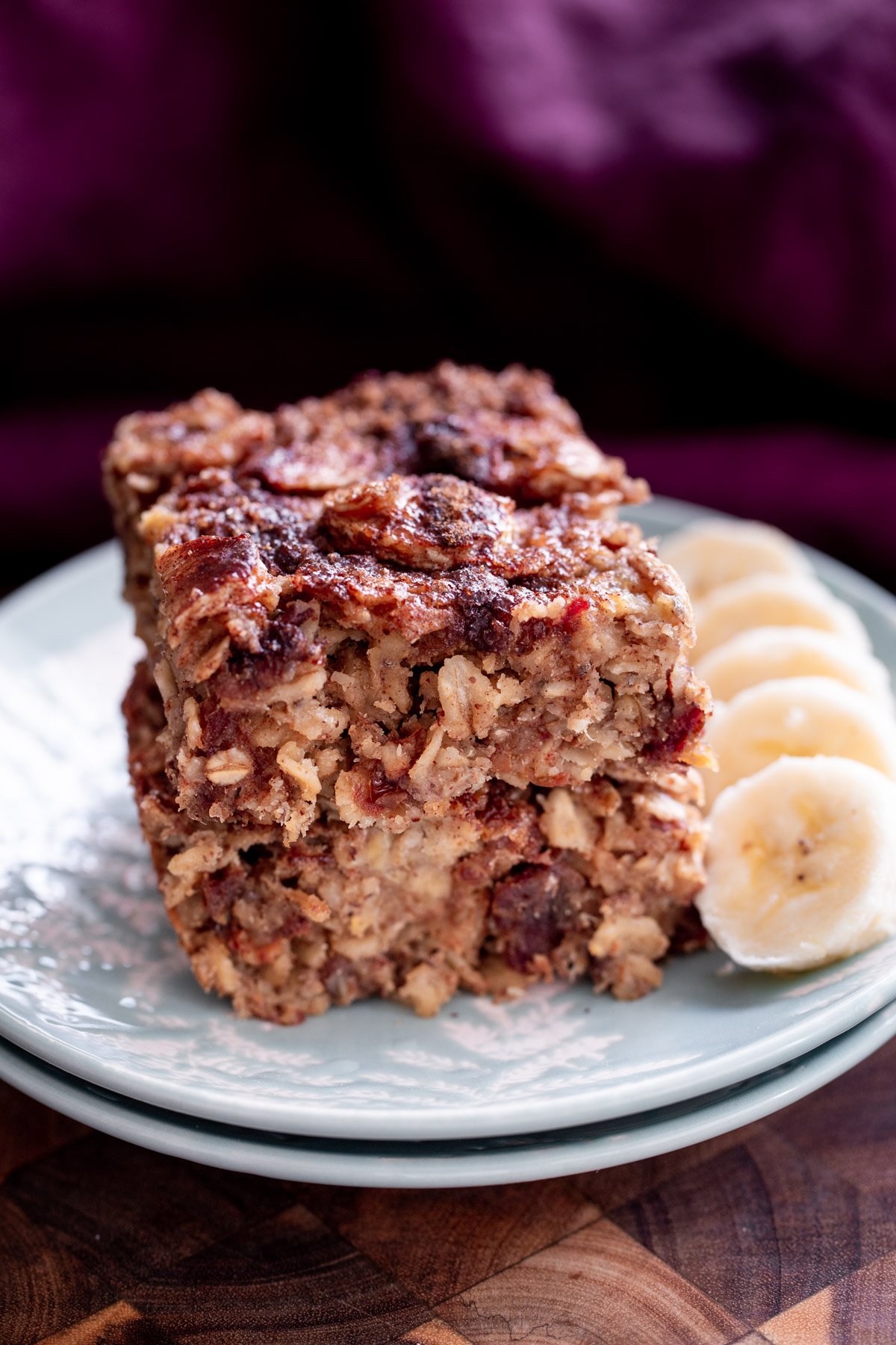 banana oatmeal bars  stacked vegan banana oatmeal bars on a white plate