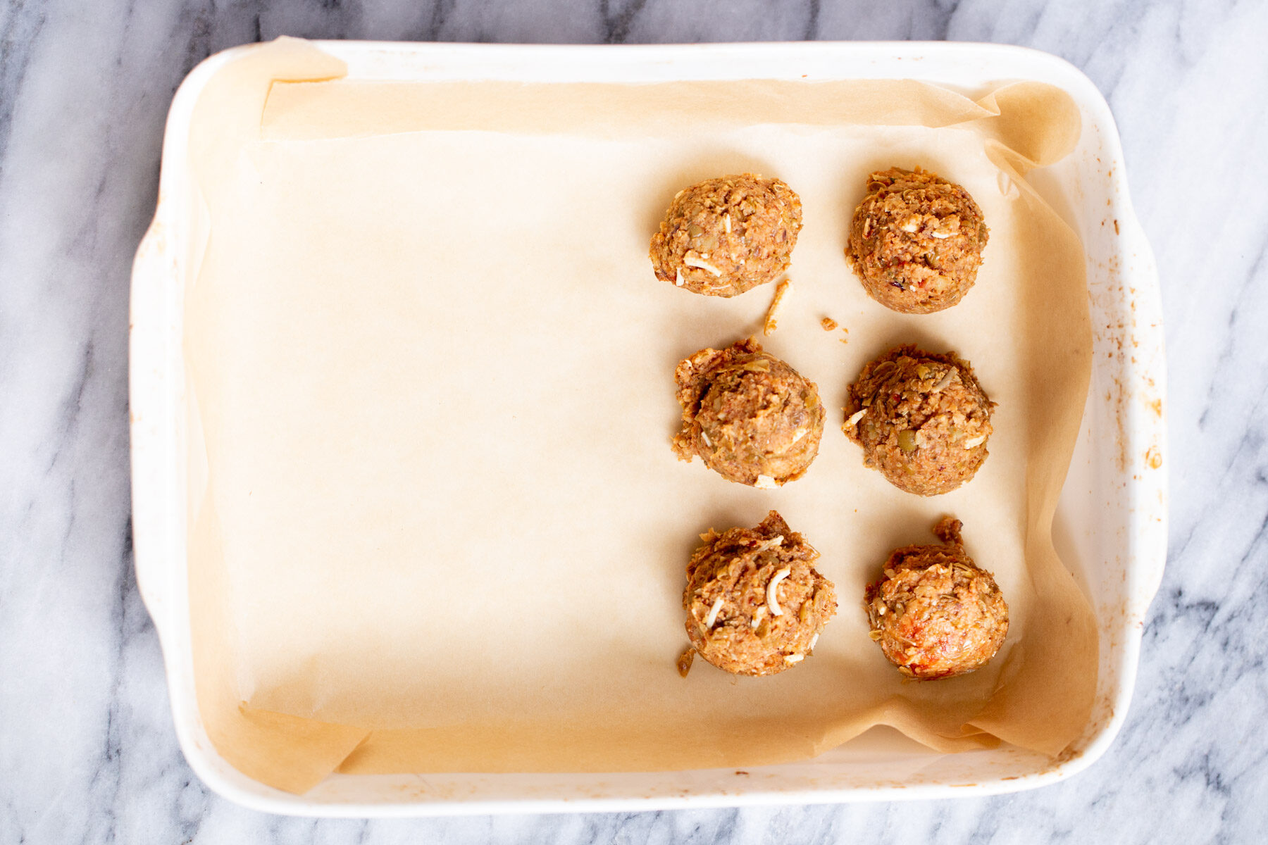 vegan lentil meatballs vegan lentil meatballs in a white casserole dish
