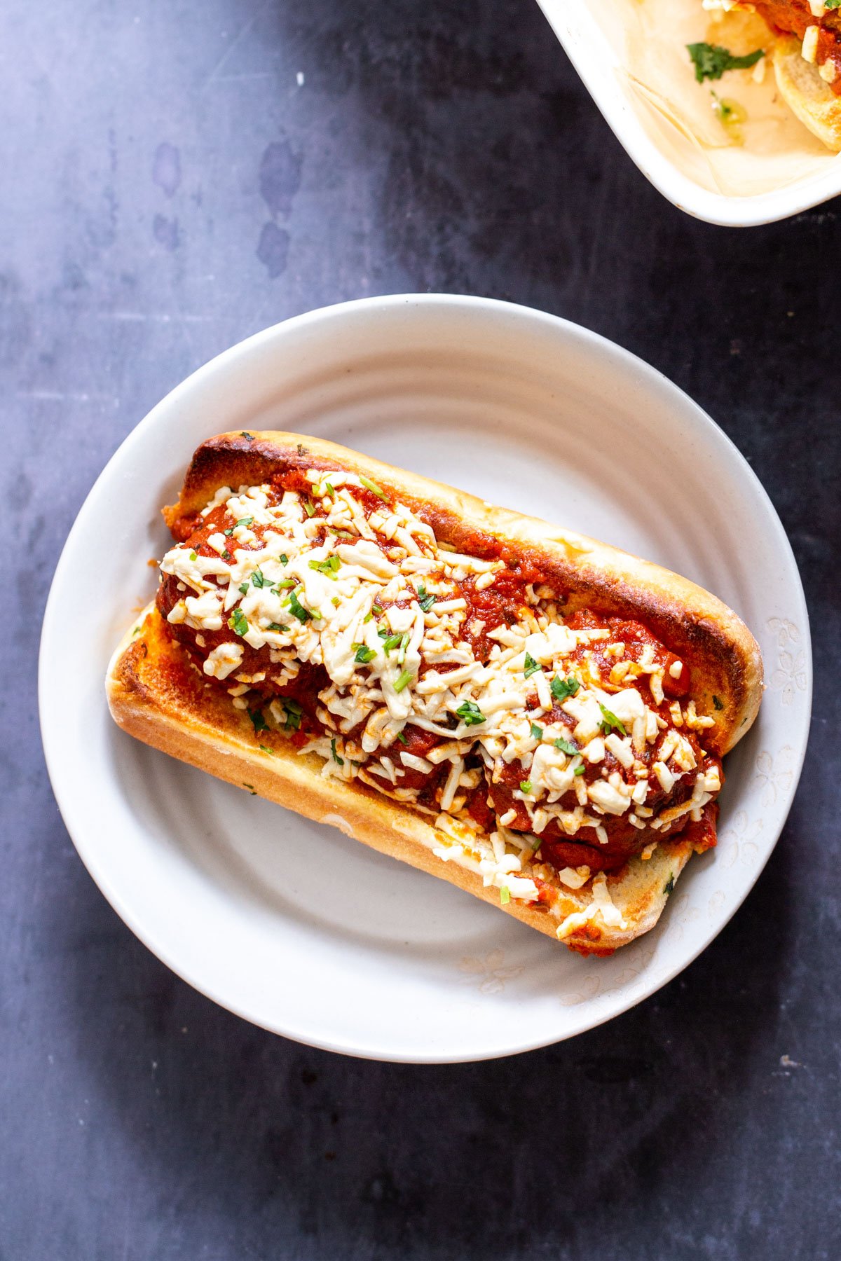 vegan meatball subs overhead shot of a vegan meatballs sub srinkled with vegan cheese shreds