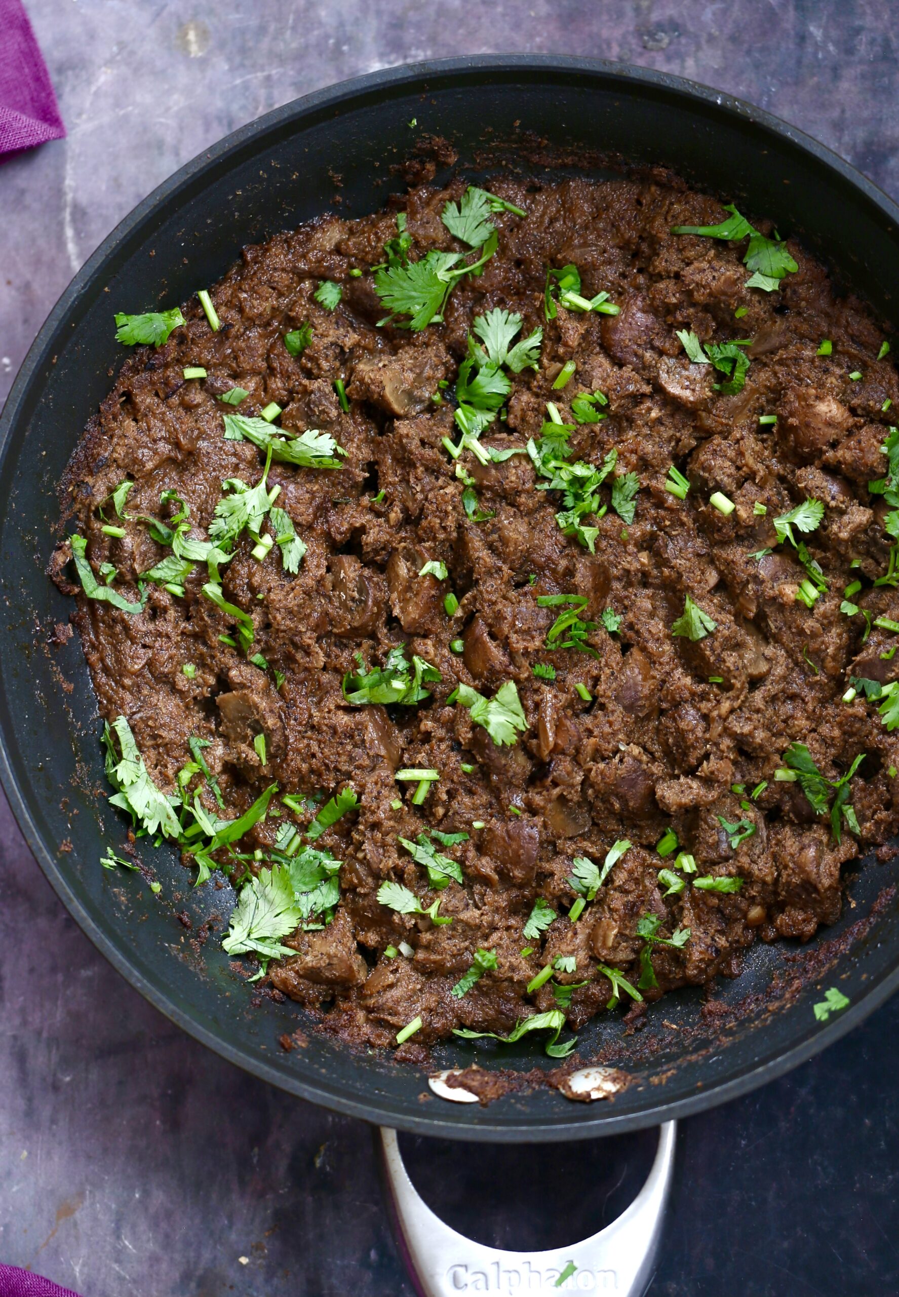 vegan mushroom xacuti in a black skillet