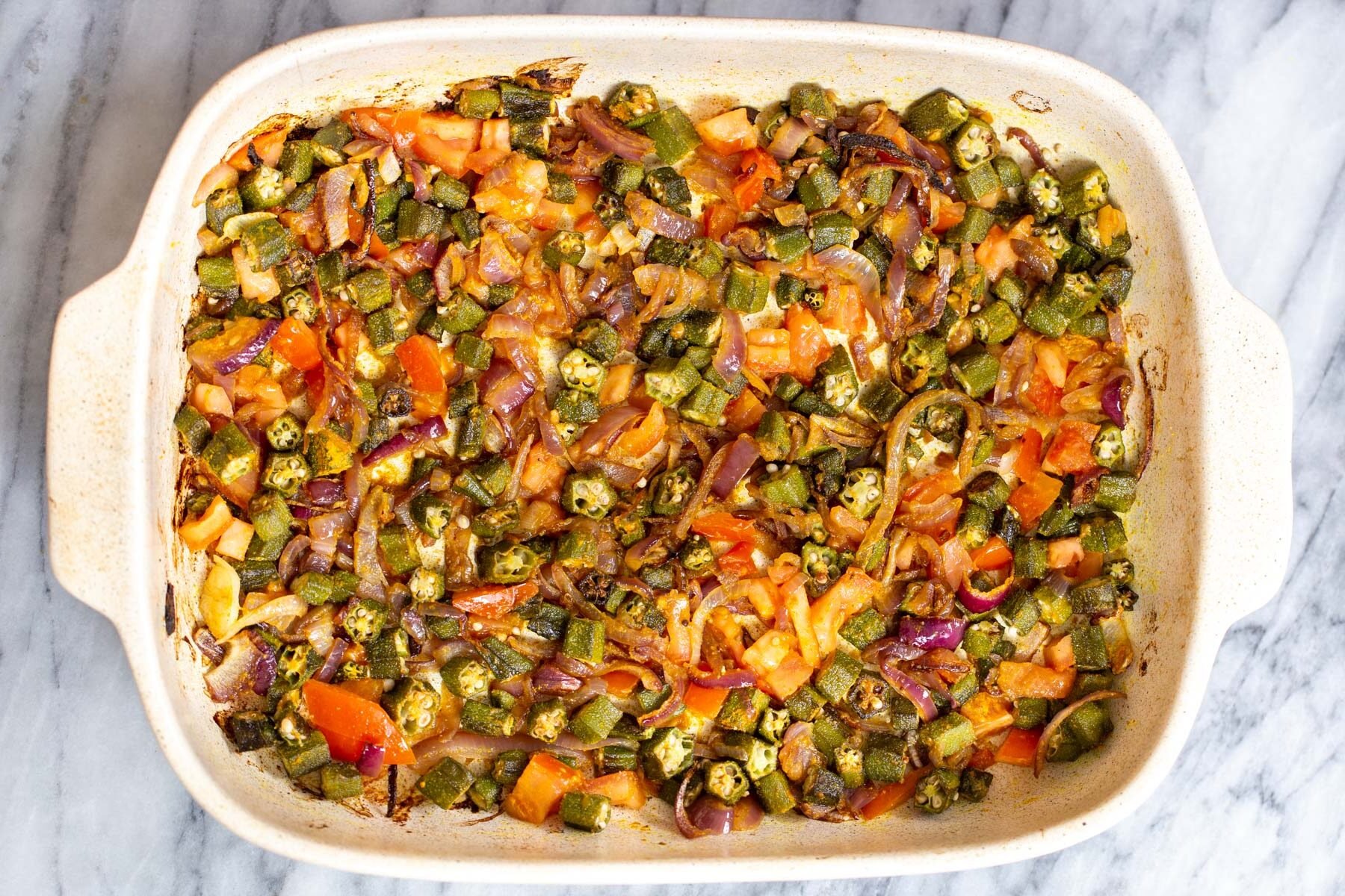 baked roasted chopped veggies in a white casserole dish