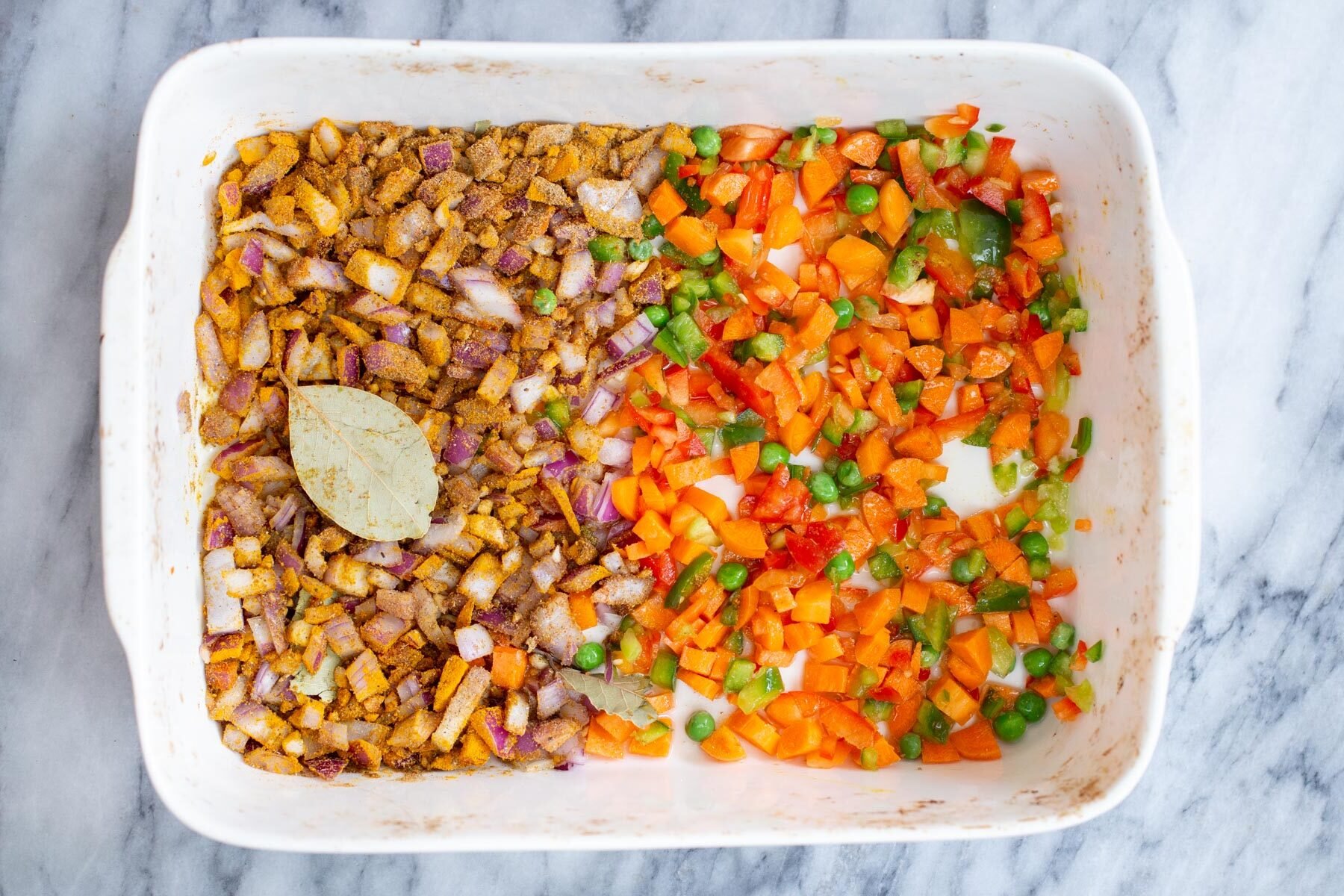 vegetables and spiced onions in a casserole dish