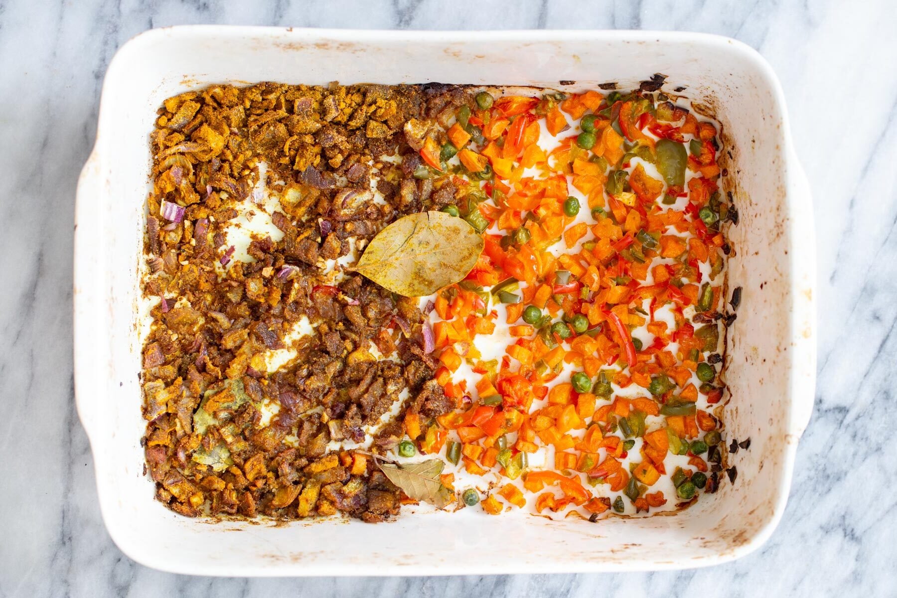 roasted spiced vegetables in a white casserole