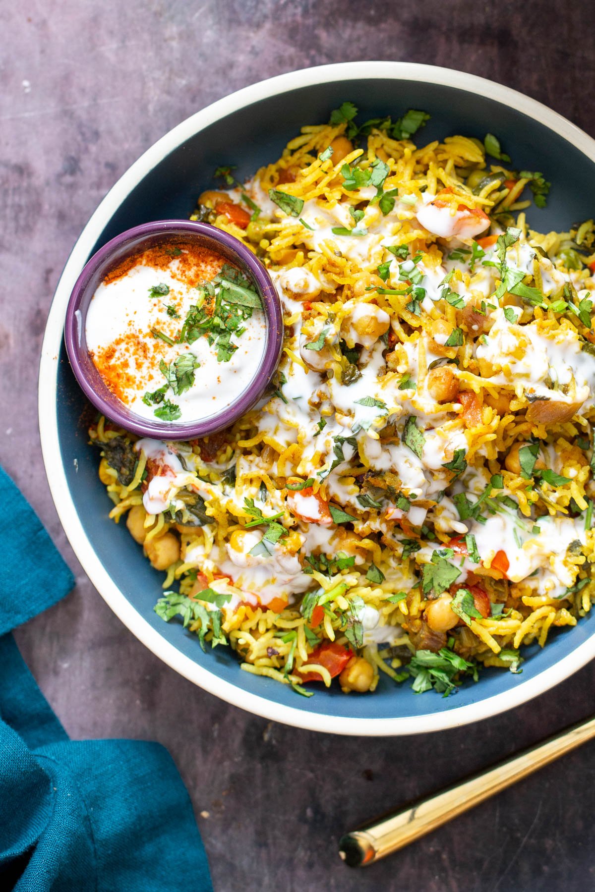 vegan pulao a blue bowl filled with chickpea rice pulao / pilaf