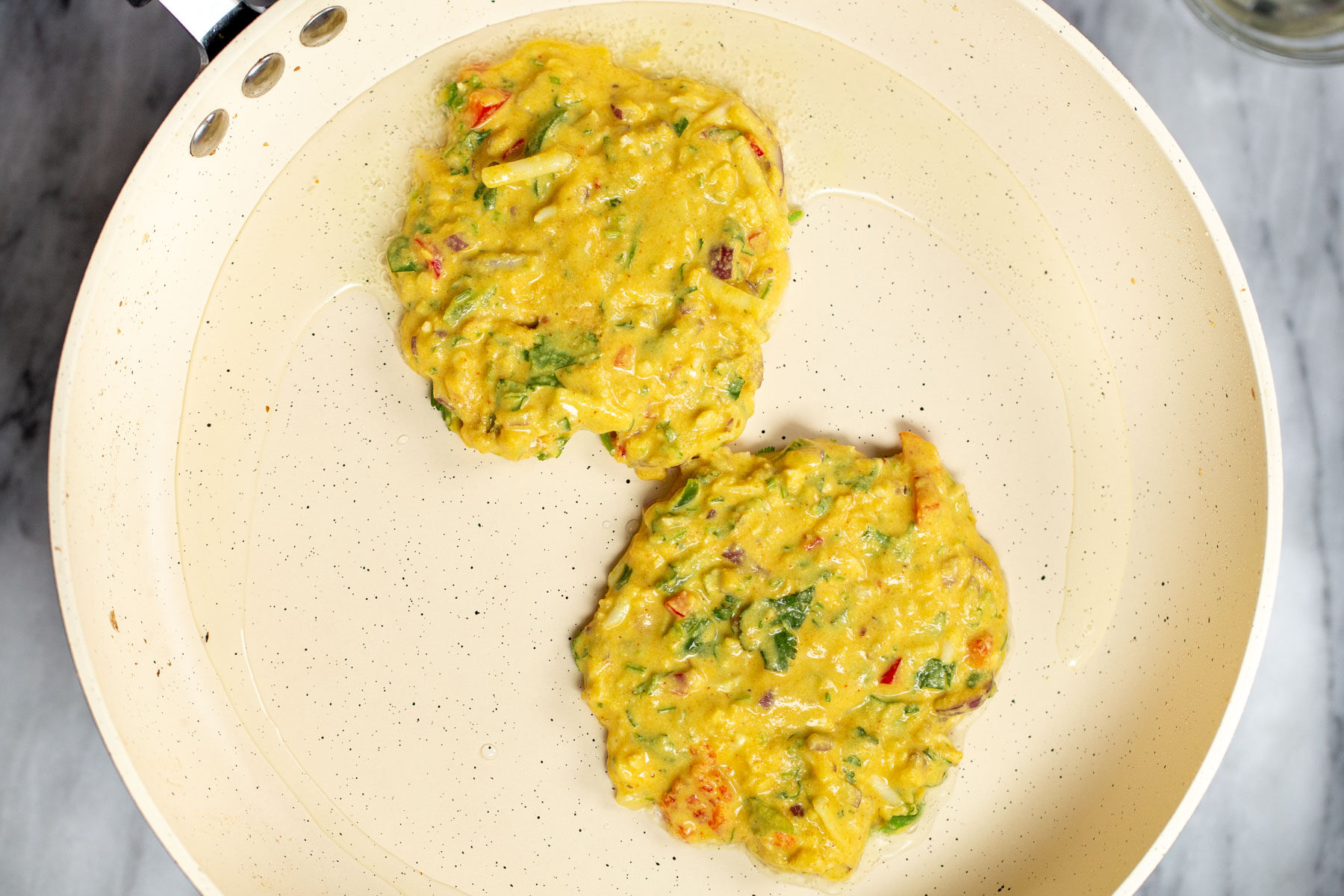 vegan chickpea flour pancakes in a white skillet