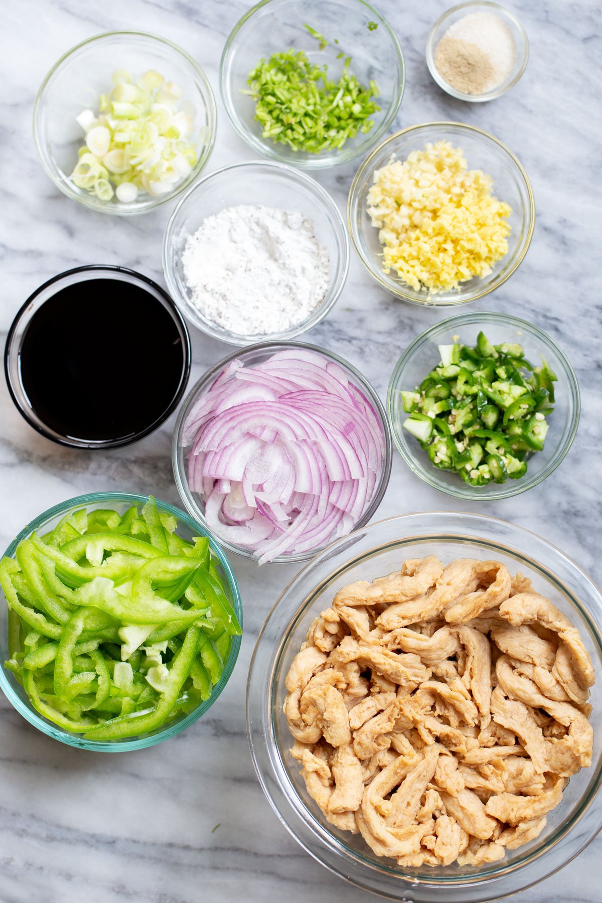 ingredients needed for vegan chilli chicken on a marble slate.