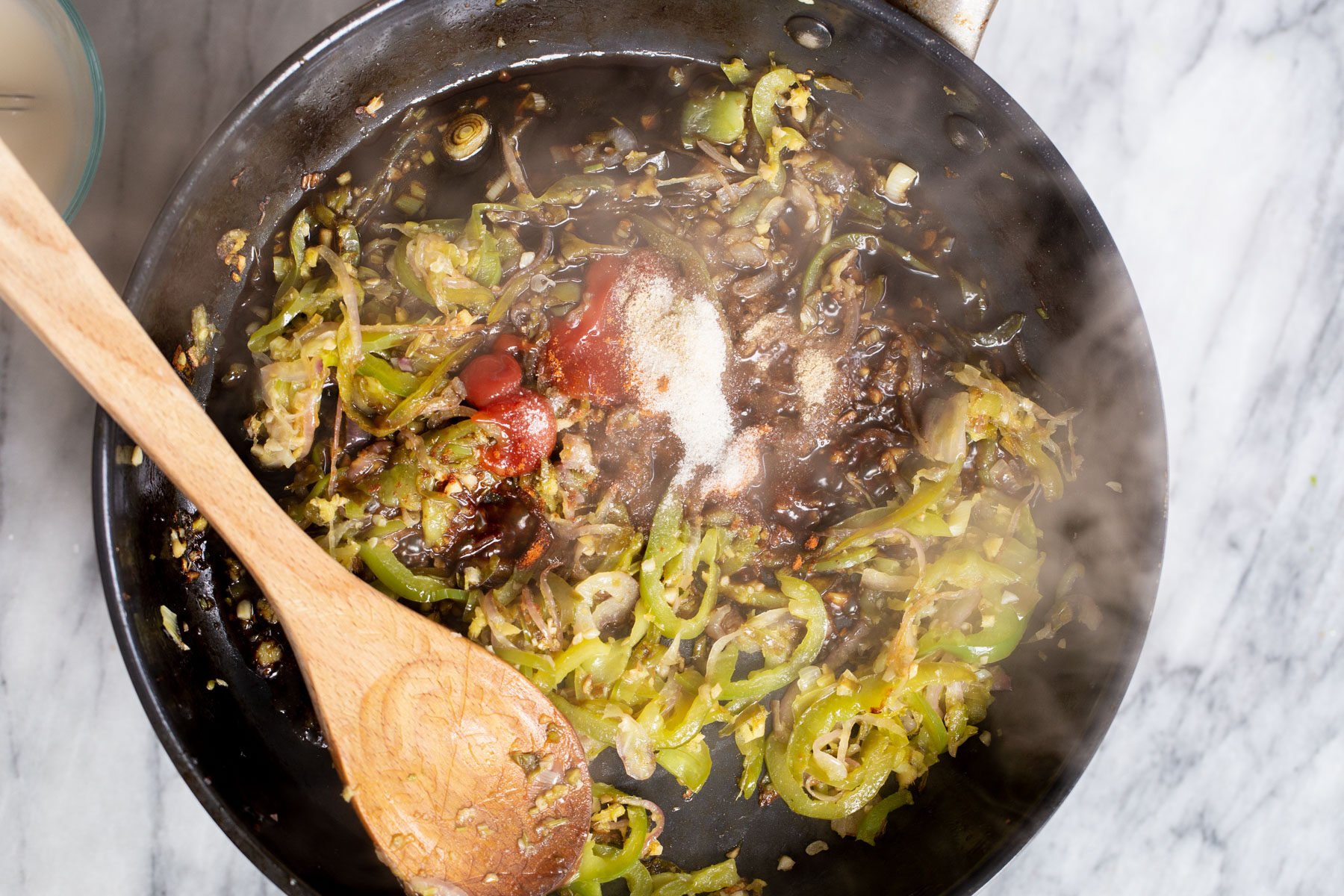 sauce ingredients being added to skillet to make Indo Chinese Chilli sauce