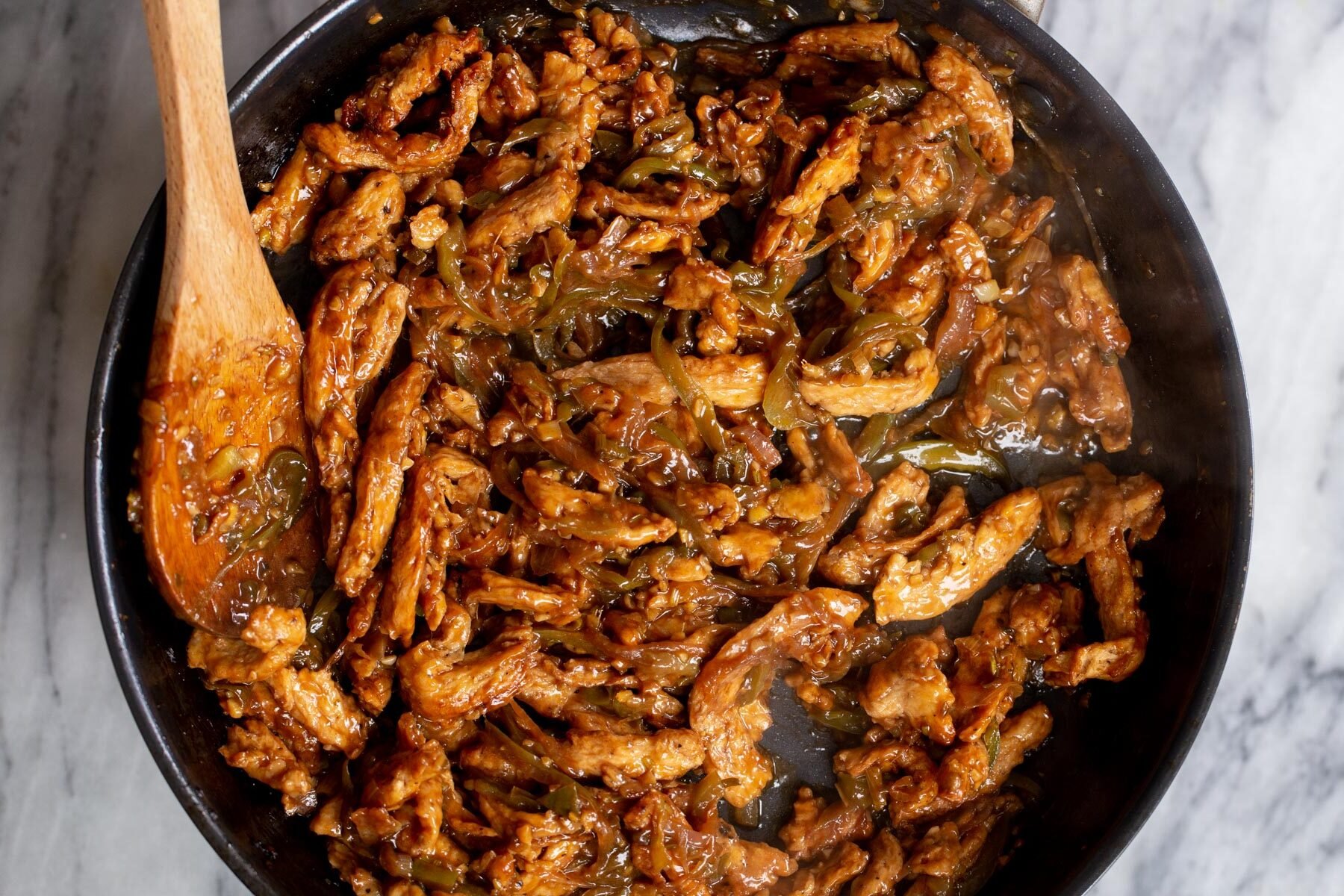 baked soy curls being tossed in green chilli sauce