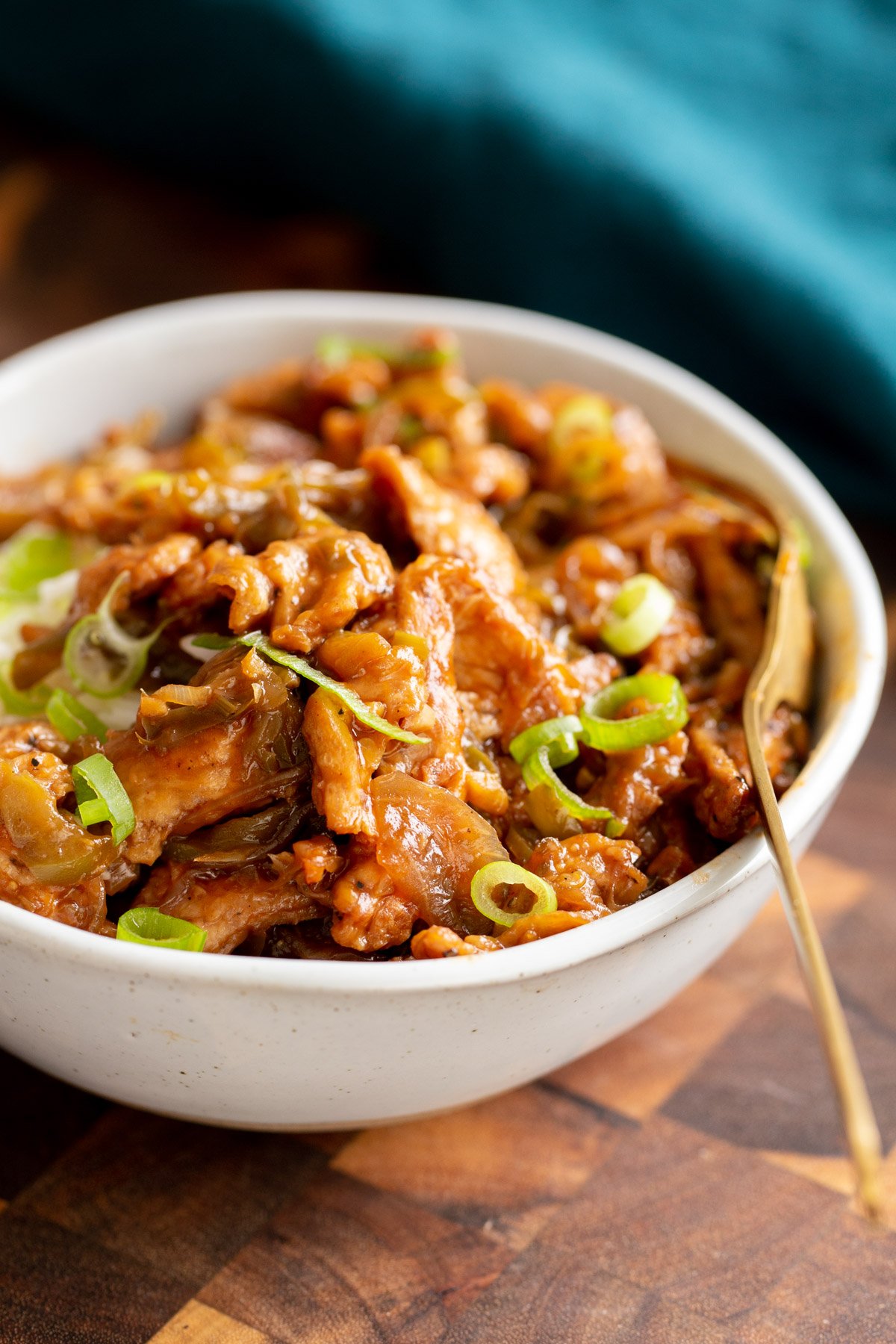 vegan chilli chicken side view of vegan soy curl chilli chicken in a white bowl
