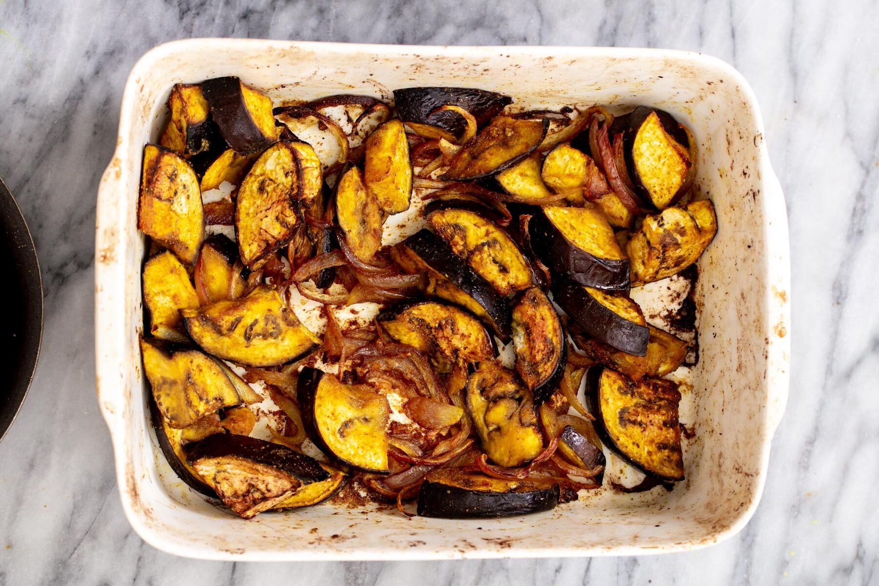 roasted eggplants in a white casserole dish