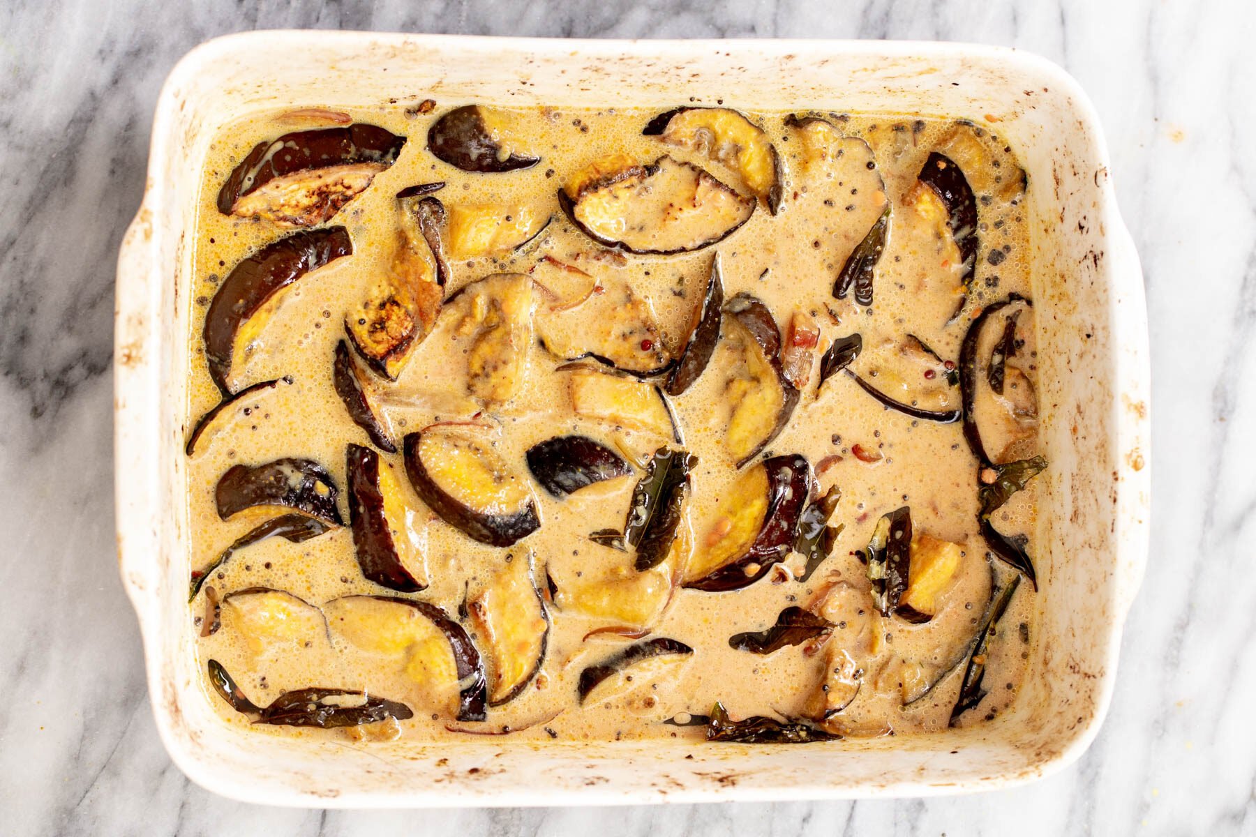 eggplant slices baking in coconut milk