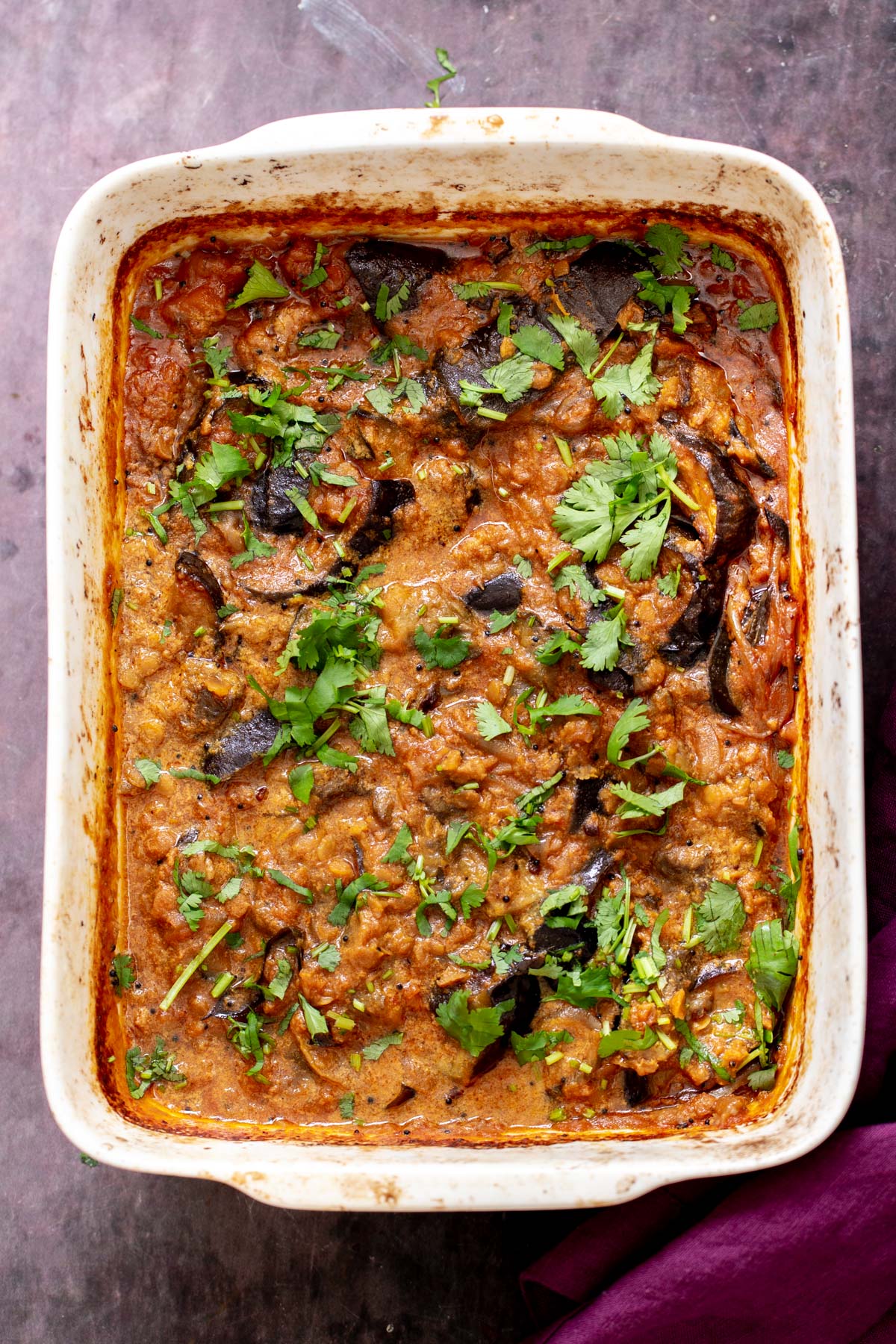 overhead shot of a casserole dish with vegan baked eggplant curry