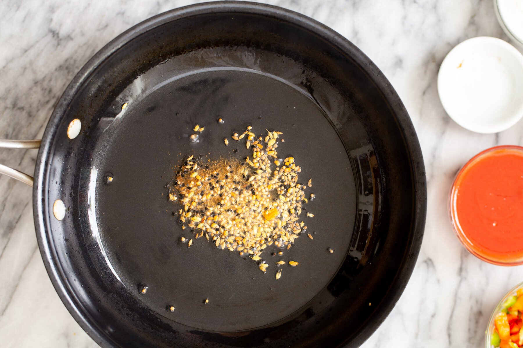spices toasted in a black skillet