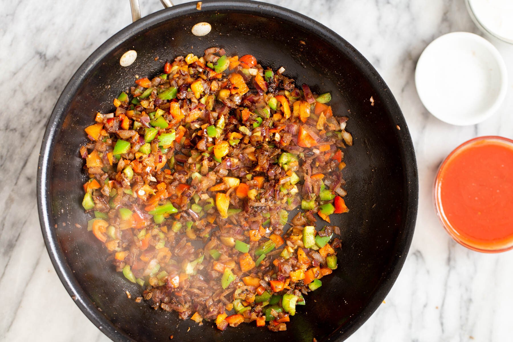 brown lentils and belle peppers in a black skillet