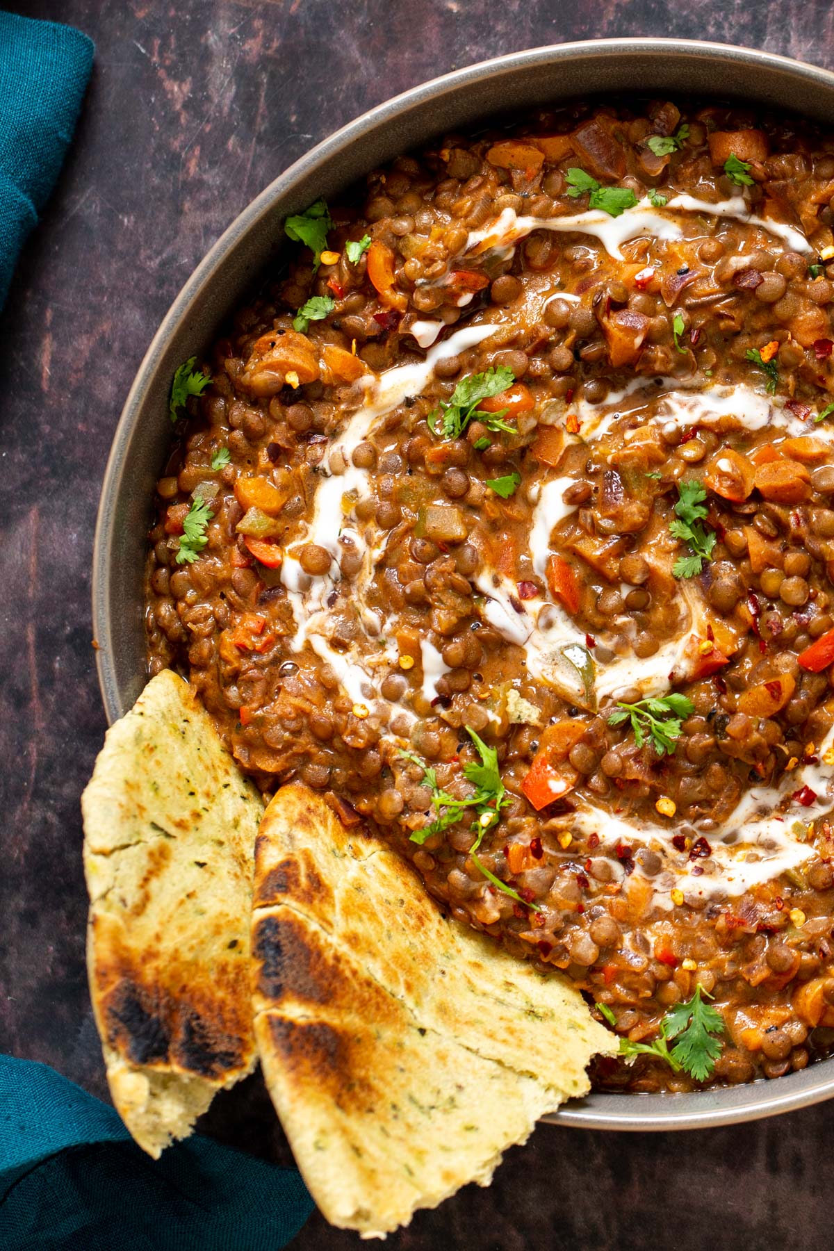 vegan handi lentils curry served with naan bread