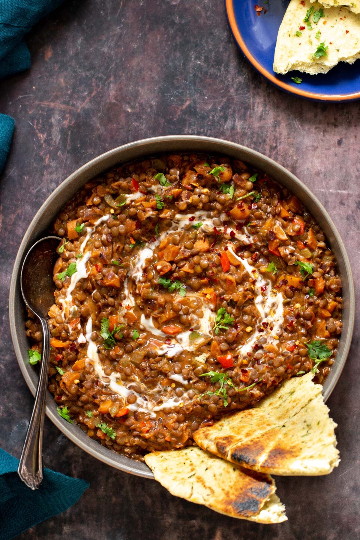 handi lentil curries with a drizzle of cashew cream served with naan